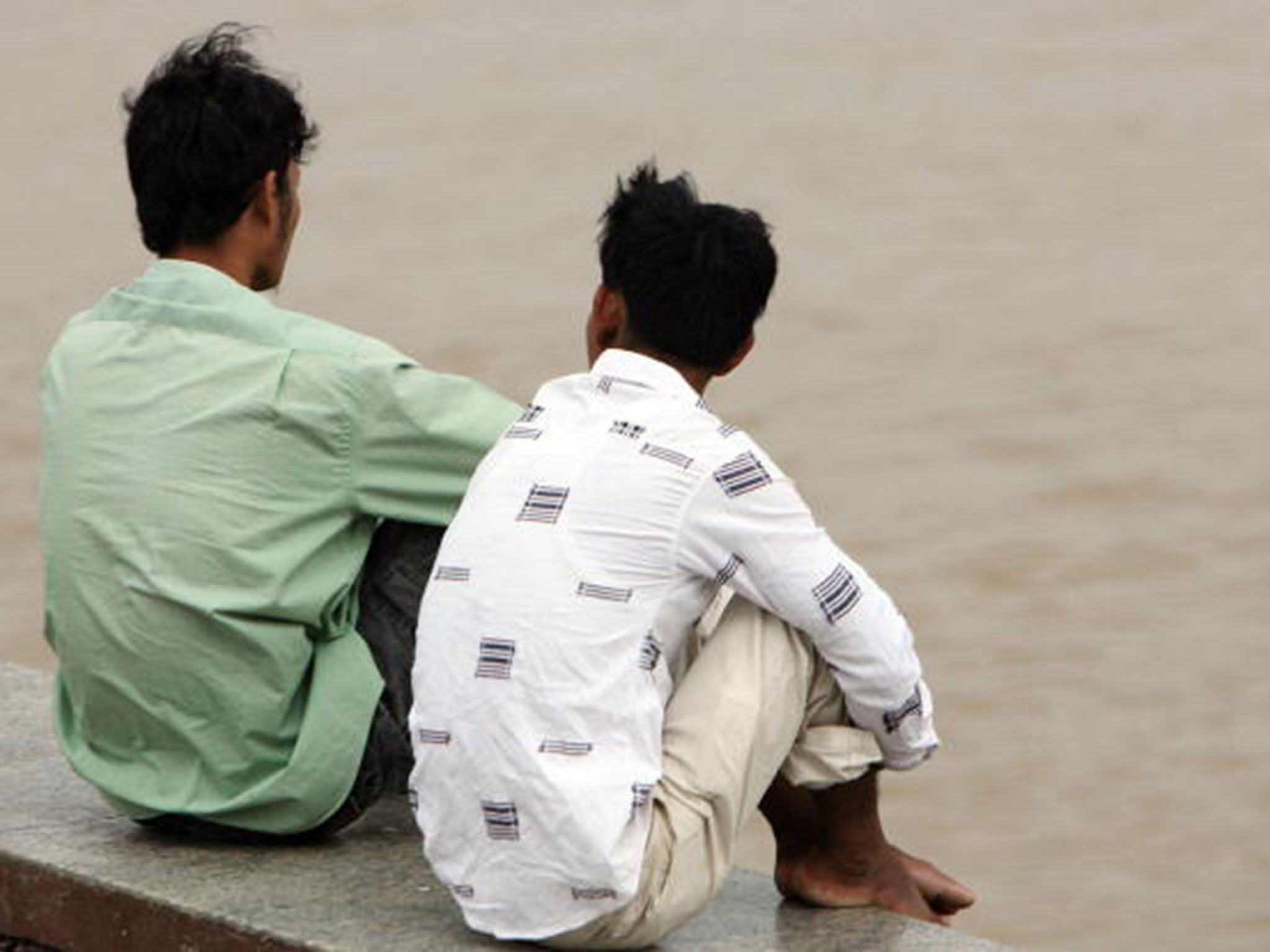 Young men gather on the busy riverside in Phnom Penh. The area is a favourite haunt of men seeking sex with other men, a growing practice here that health officials say is undermining HIV/Aids prevention efforts