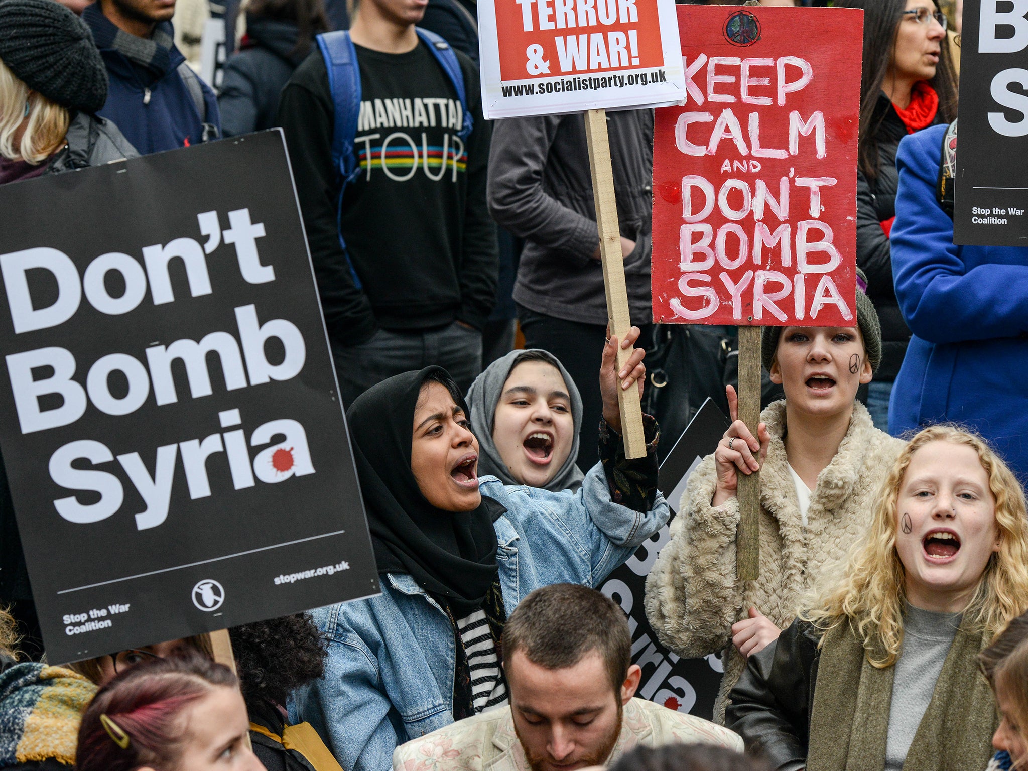 Protesters sit down in the middle of the road during a day of protest outside Downing Street against the possible British involvement in the bombing of Syria, in London. UK anti-war organisation, Stop the War Coalition, organised the protest in response to the proposed vote in Parliament by David Cameron to involve British forces in the bombing of ISIS targets in Syria