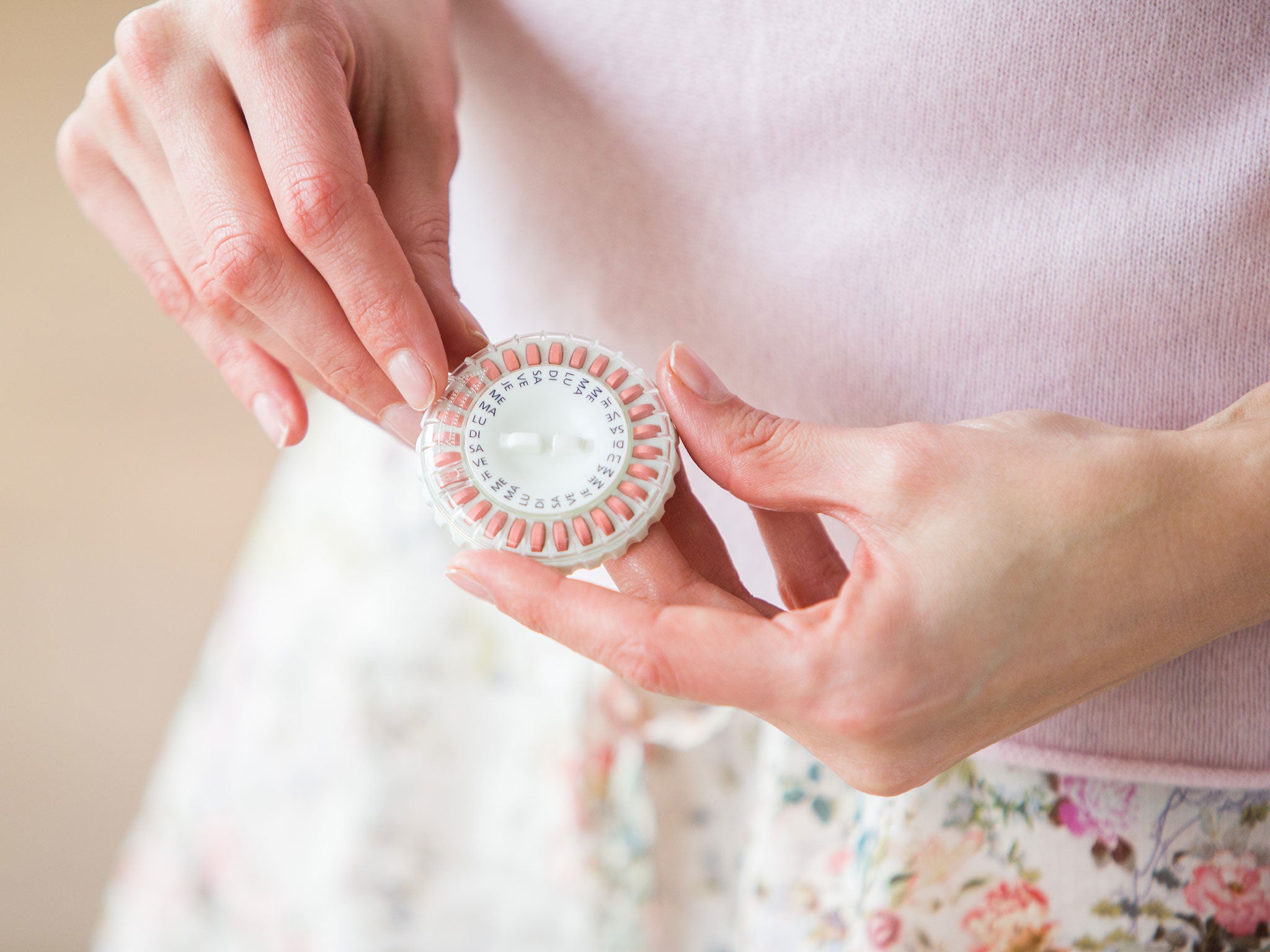 Woman taking an hormone replacement therapy pills.