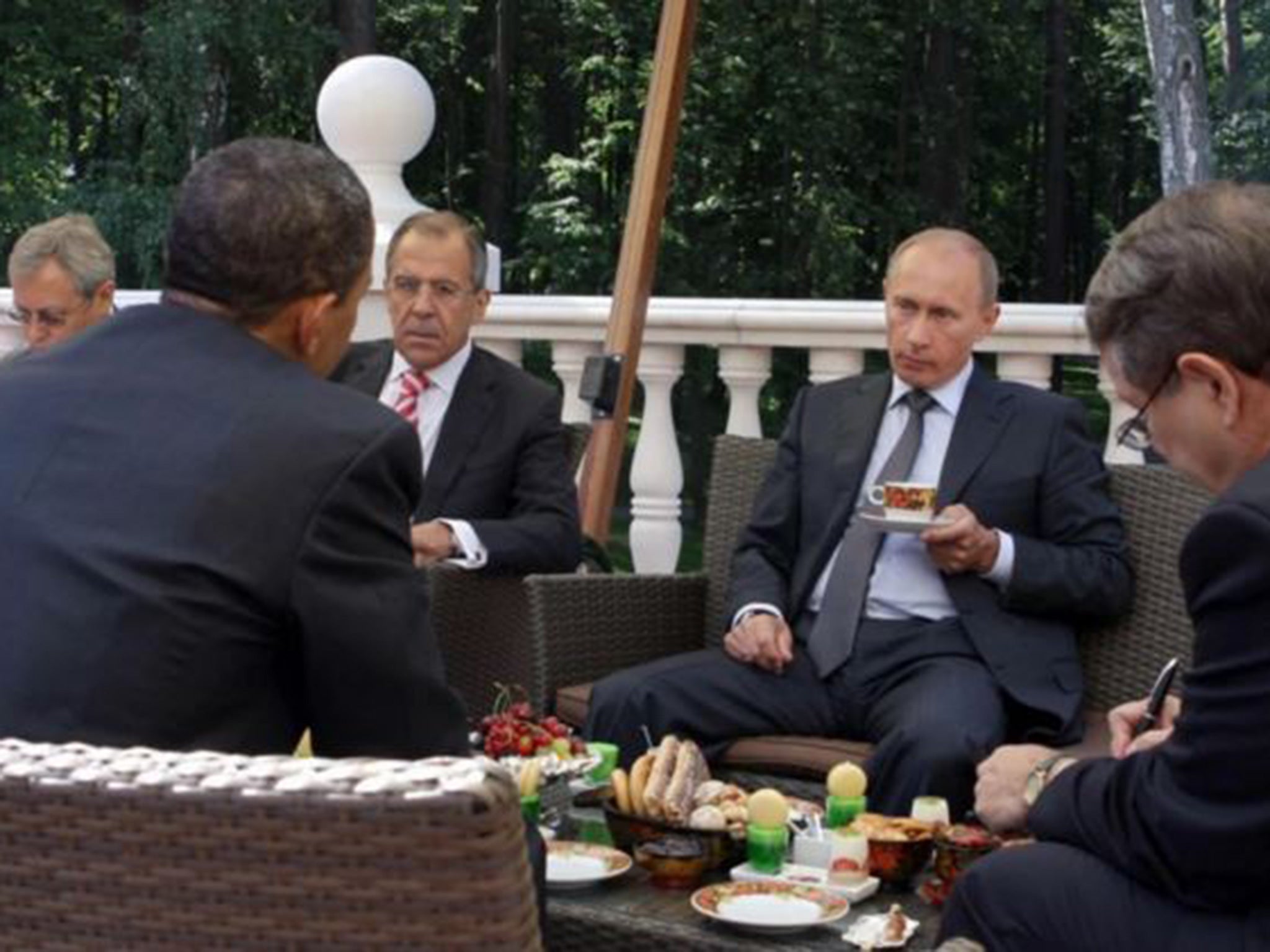 President Obama and Russian Prime Minister Vladimir Putin, center right, converse while having traditional Russian tea on a terrace at Putin's residence outside Moscow on July 7, 2009