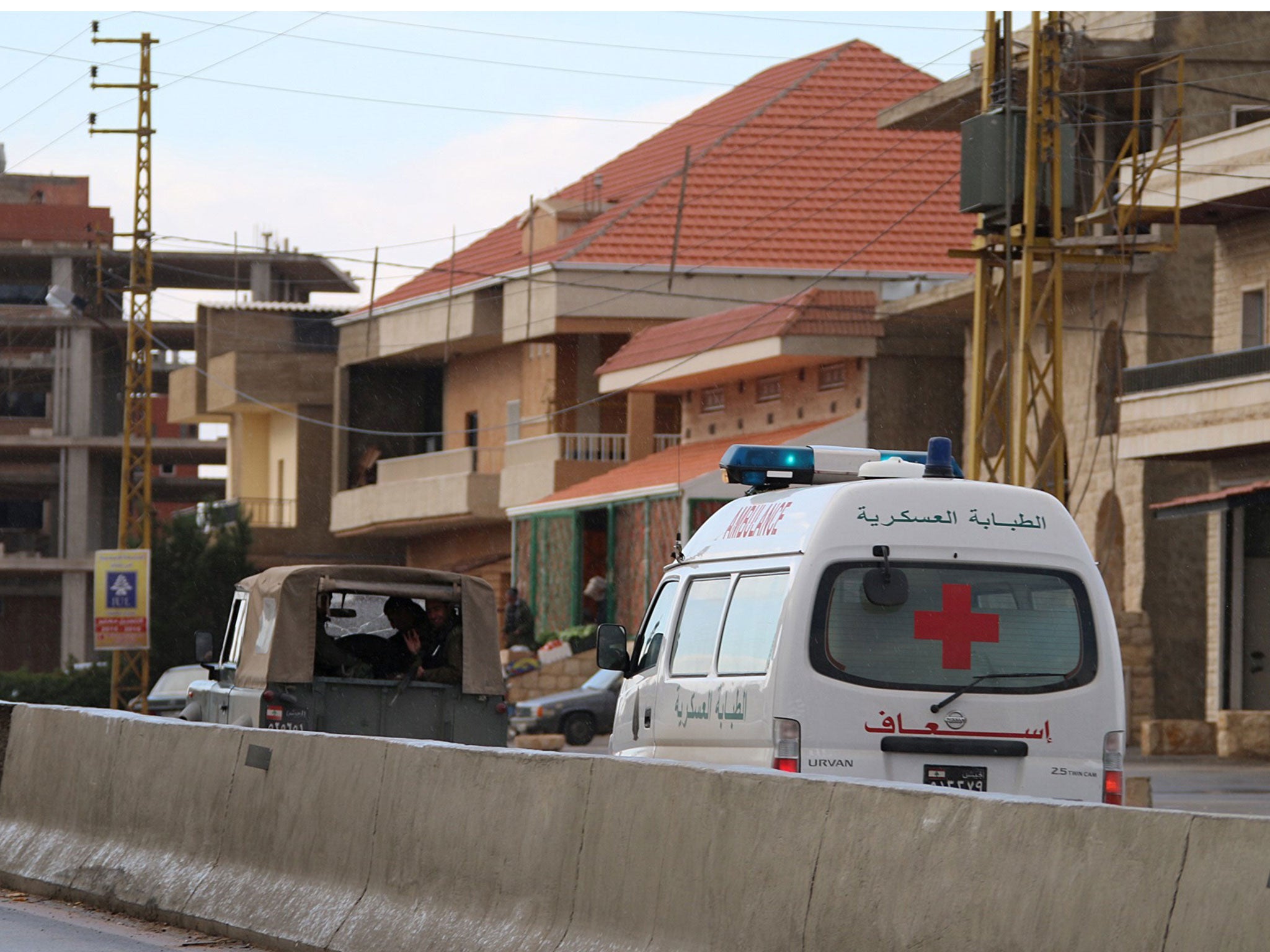 A Lebanese Red Cross ambulance carries the body of Mohammed Hammiya, a Lebanese soldier executed last year by Al-Qaeda's Syrian affiliate Al-Nusra Front, after it was handed over to the authorities on December 1, 2015