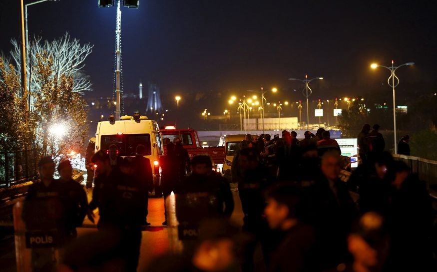 Riot police secure the scene of the explosion