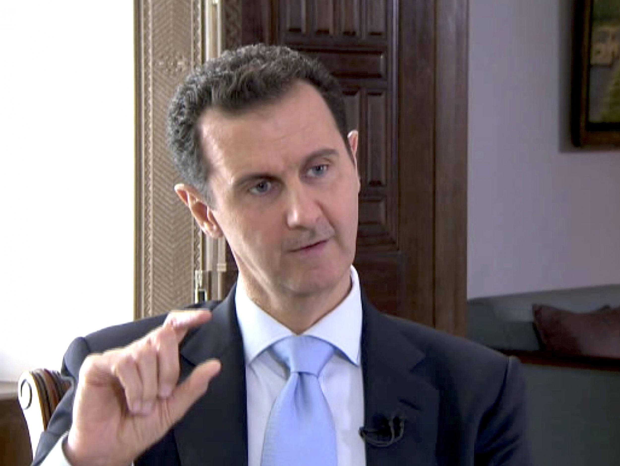 Syrian President Bashar al-Assad speaks during a TV interview in Damascus