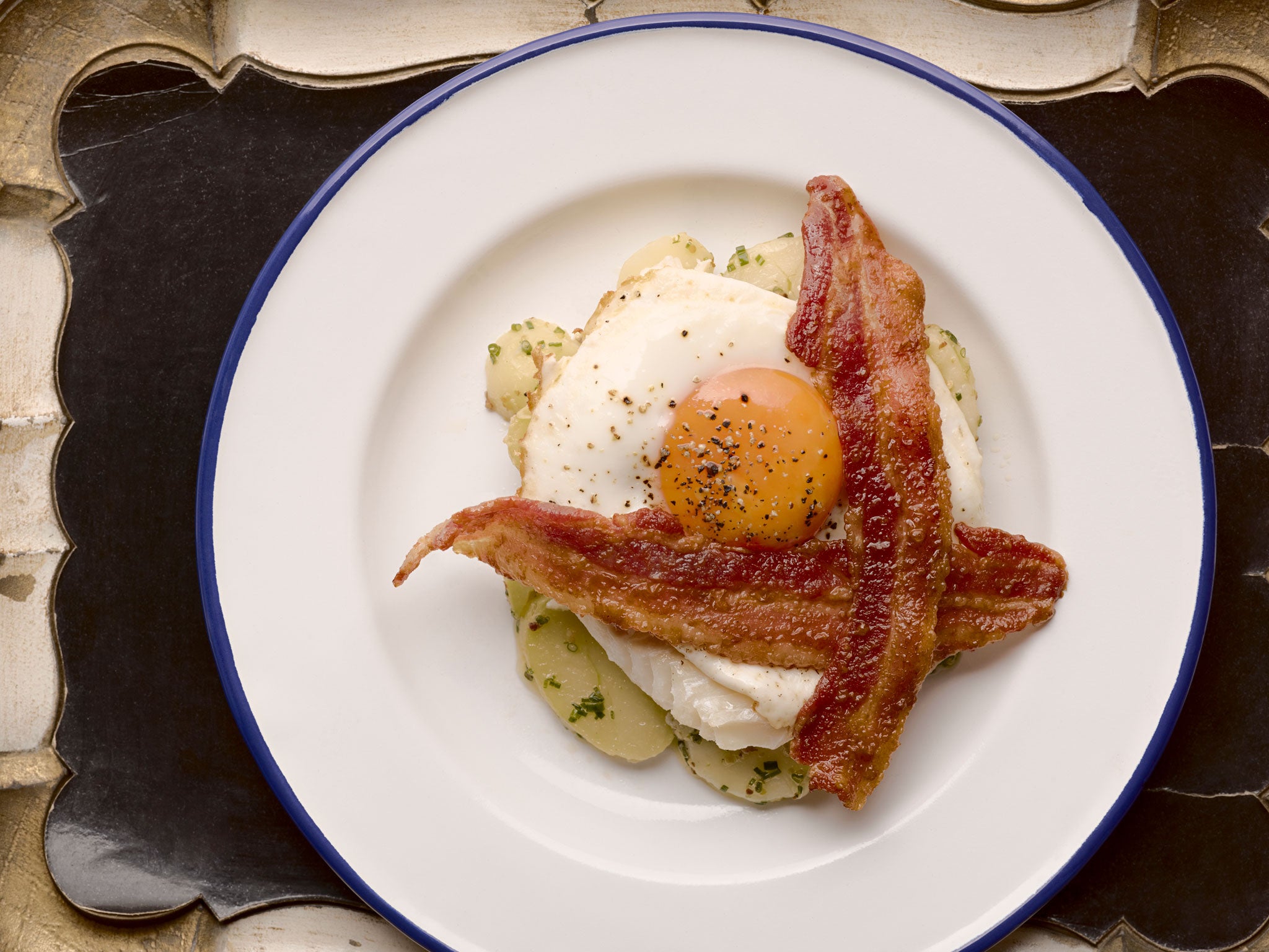 Poached haddock with potatoes, egg and crispy bacon