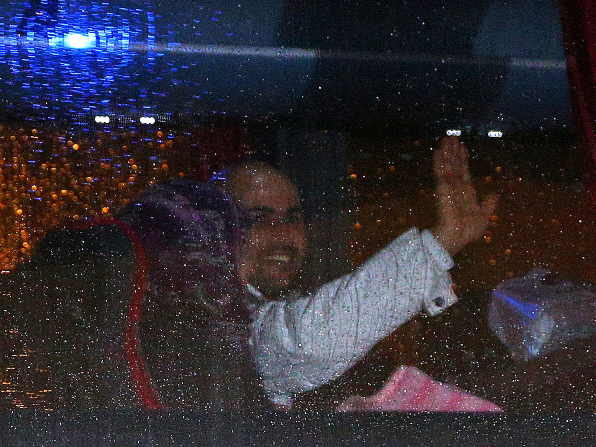 Refugees look out the window as they leave Glasgow Airport on buses after the first of a series of charter flights carrying refugees arrived on November 17, 2015 in Glasgow, Scotland