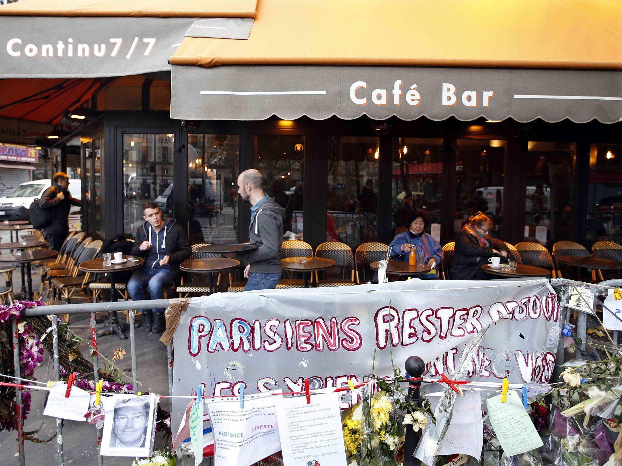 Customers sit on the terrace of the "A La Bonne Biere" cafe in Paris, France, December 4, 2015, as it re-opens for business