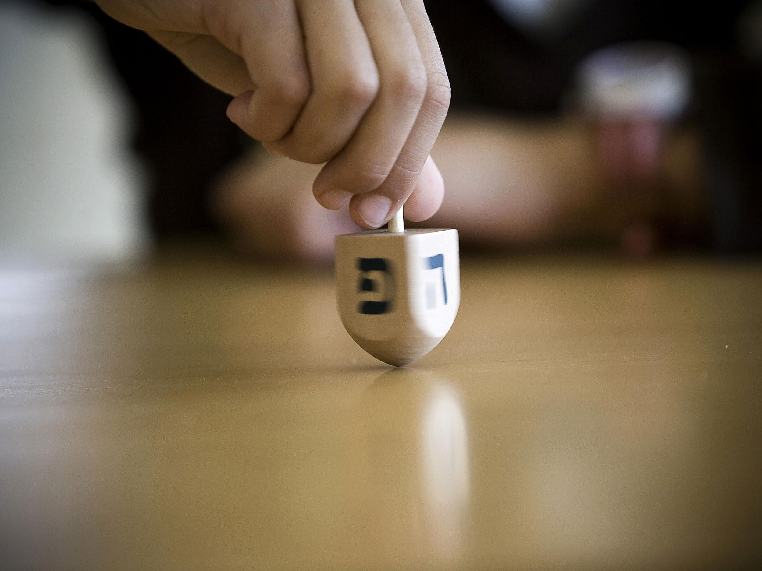 A Dreidel is spun as part of a competition during the Jewish festival of Hanukkah