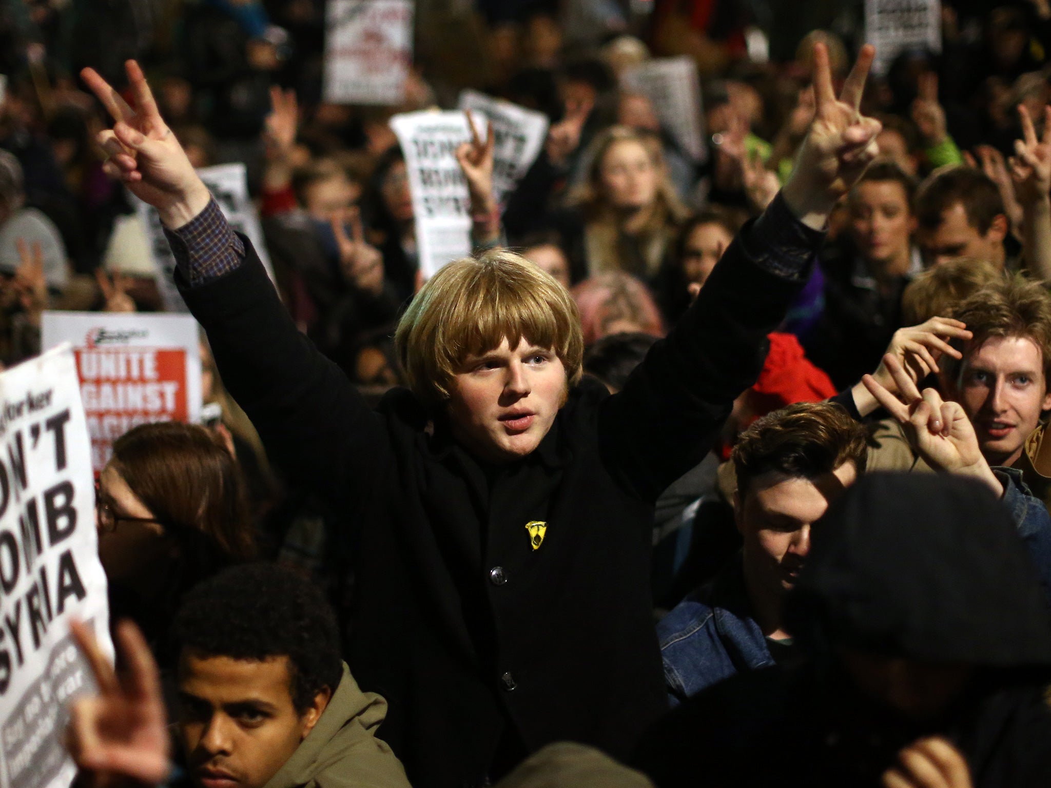 A demonstrator gestures as he protests against British airstrikes against in Syria outside Parliament