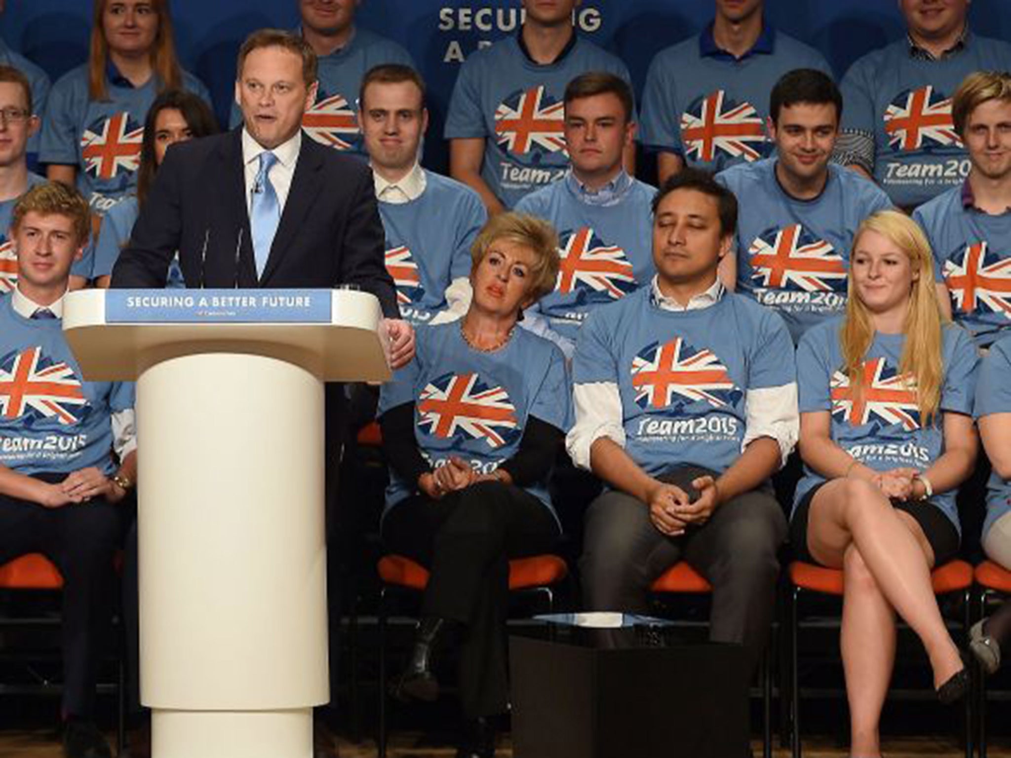 Grant Shapps addressing the room during the Conservative Party annual conference with Mark Clarke