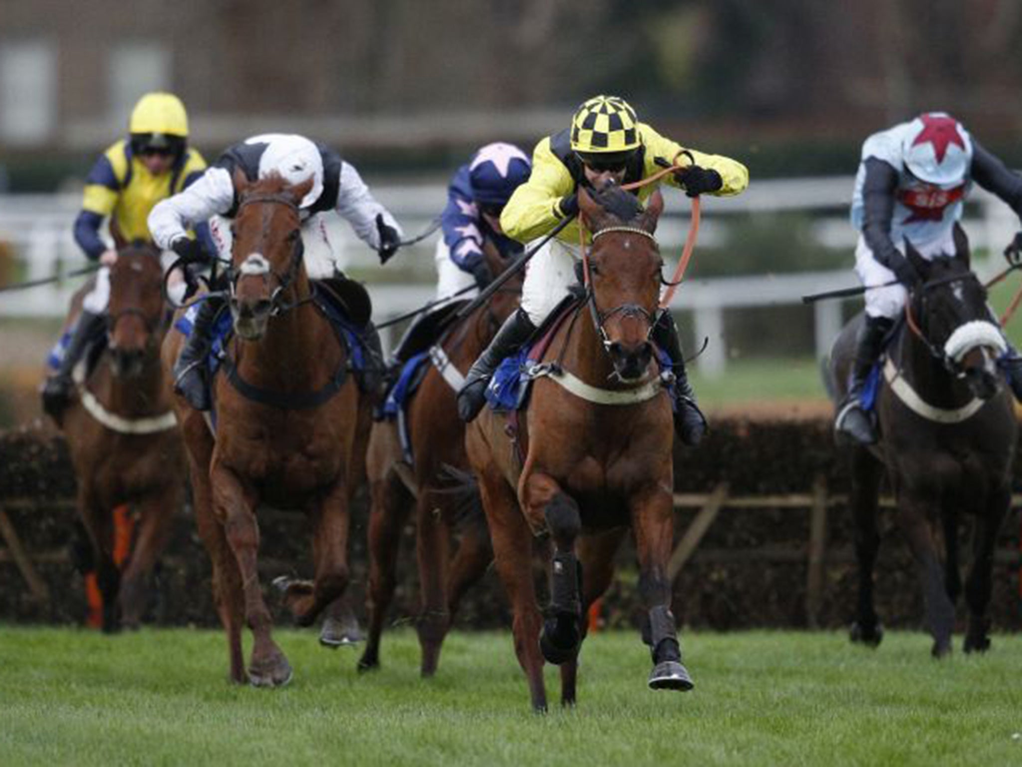 Label Des Obeaux (centre), ridden by Wayne Hutchinson and trained by Alan King, wins the Winter Novices’ Hurdle at Sandown yesterday