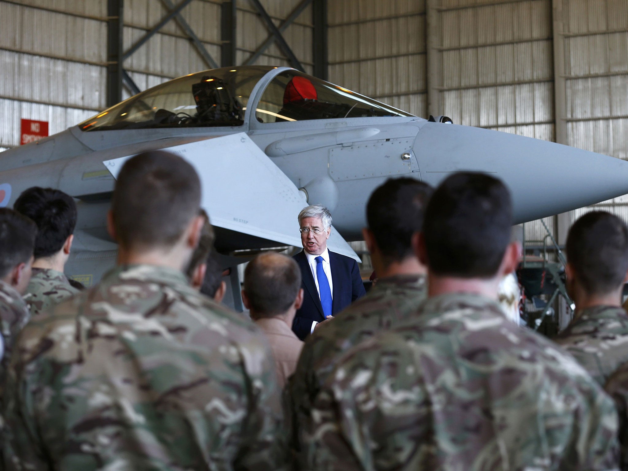 Britain's Secretary of State for Defense Michael Fallon speak to British Royal Air Force personnel in front of a Typhoon during a visit to RAF Akrotiri in southern Cyprus December 5, 2015.