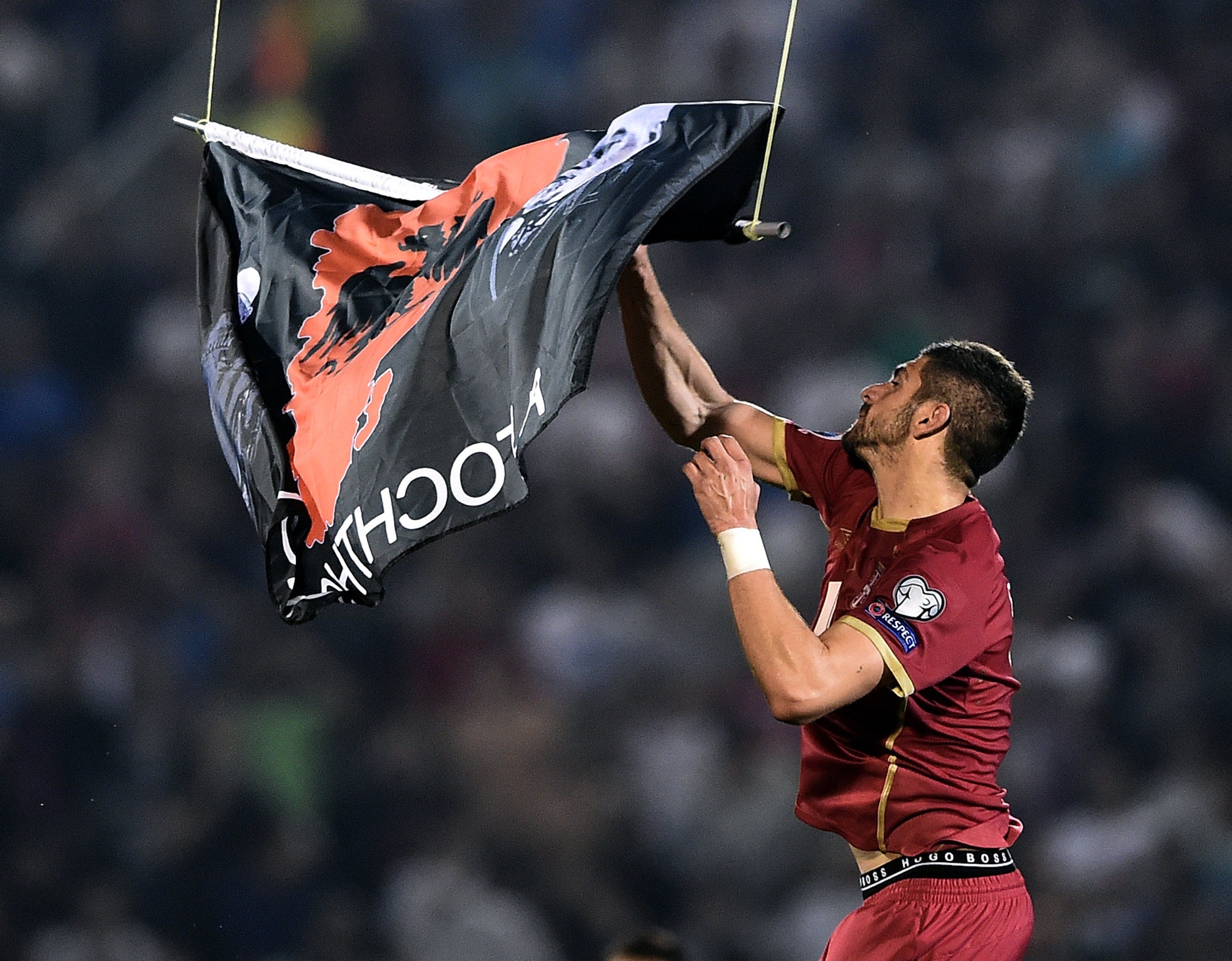 A Euro 2016 qualifying match between Albania and Serbia was abandoned after a drone carrying a pro-Albanian banner was flowing over the pitch