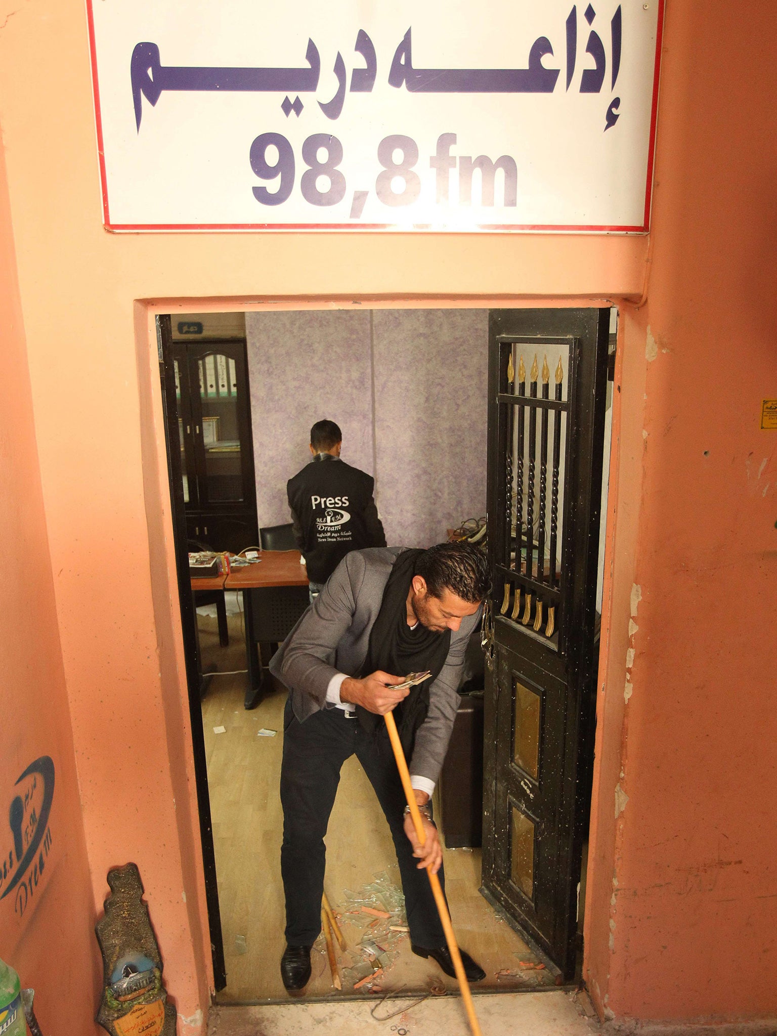 Palestinian Dream radio staff clean up after a raid