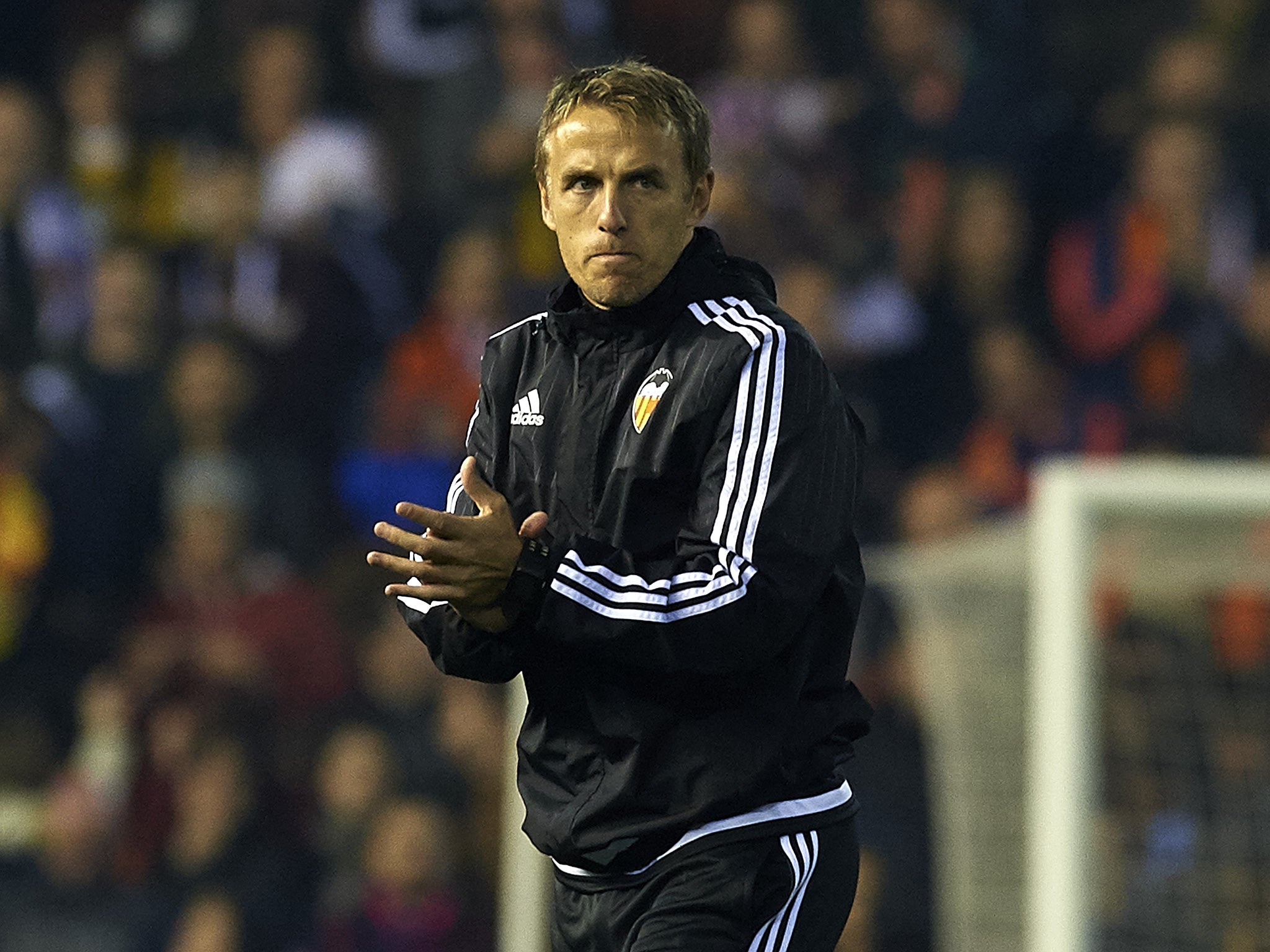 Phil Neville applauds Valencia’s players after the 1-1 draw with Barcelona