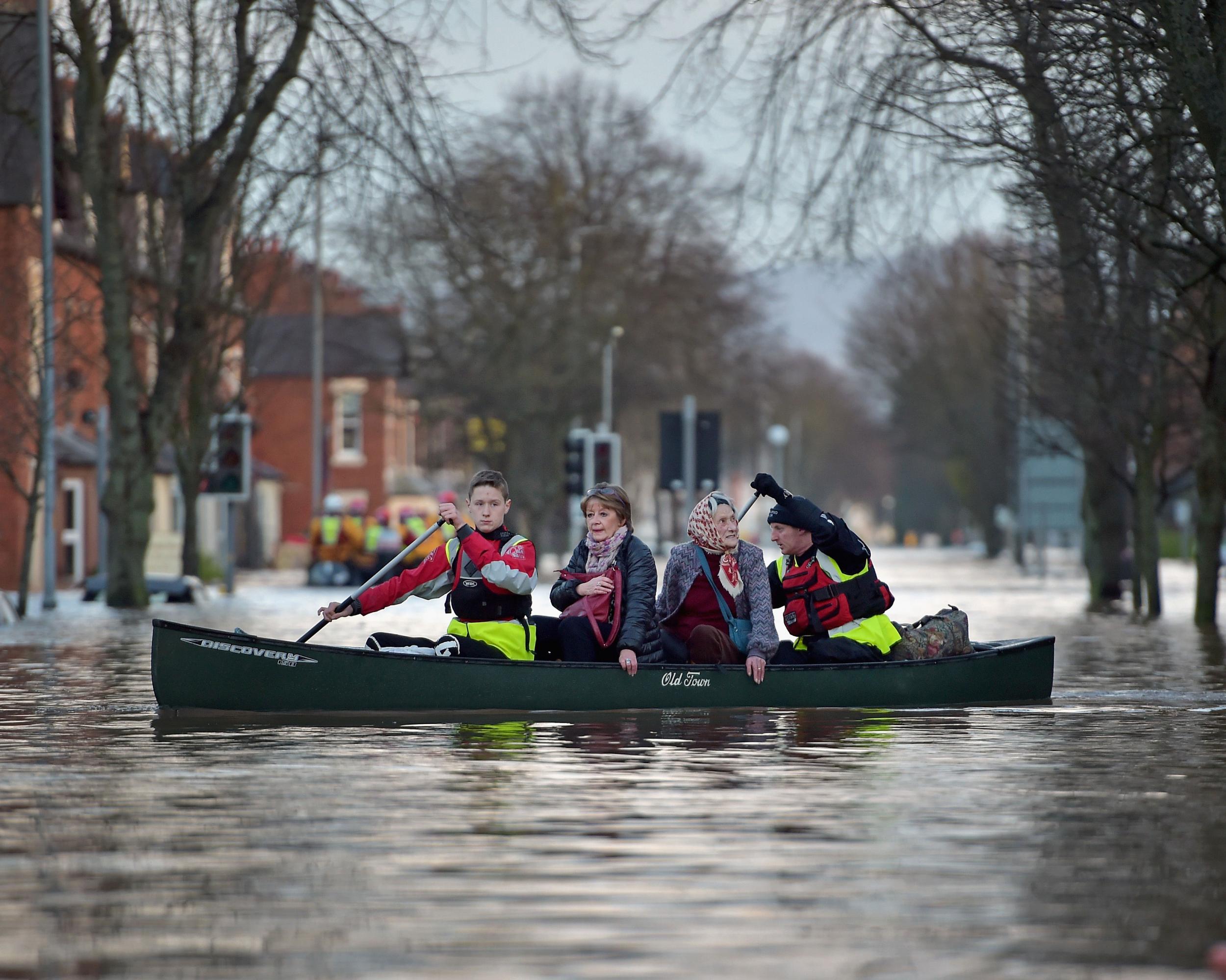 A rescue team helps to evacuate people from their homes after Storm Desmond floods Carlisle