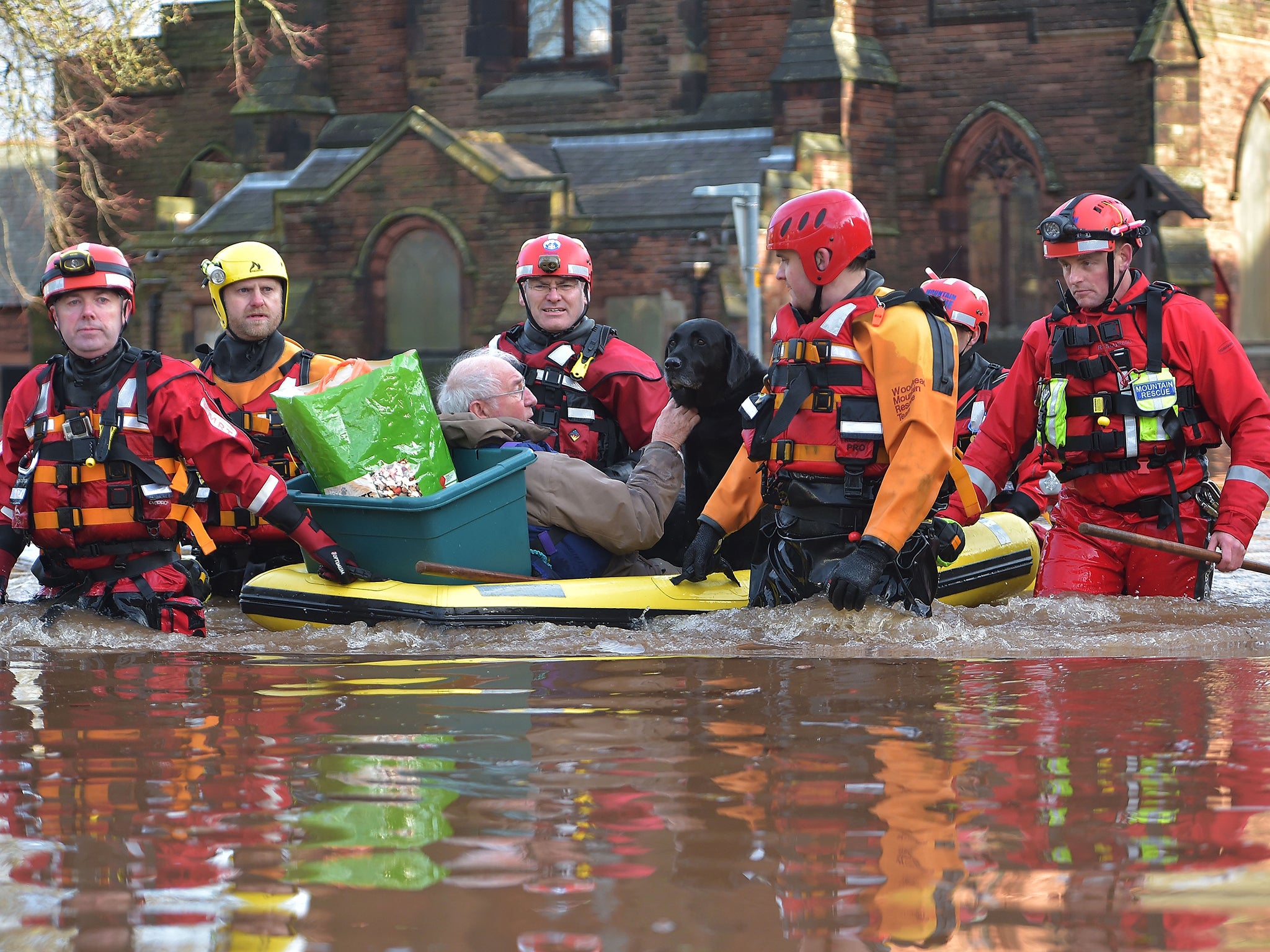 A rescue team helps to evacuate people from their homes after Storm Desmond caused flooding in Carlisle. Storm Desmond has brought severe disruption to areas of northern England as dozens of flood warnings remain in place