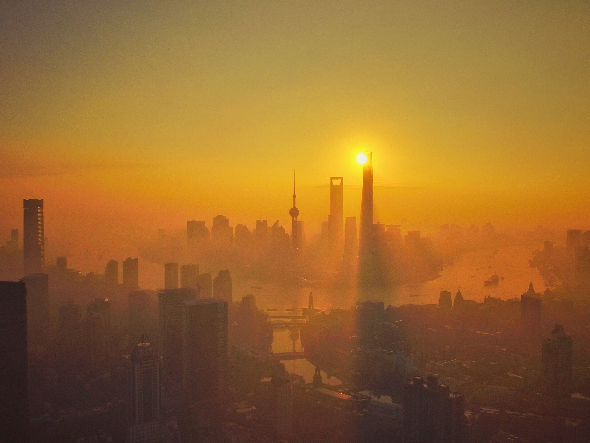 Skyscrapers and high-rise buildings in Pudong at sunrise in heavy smog in Shanghai