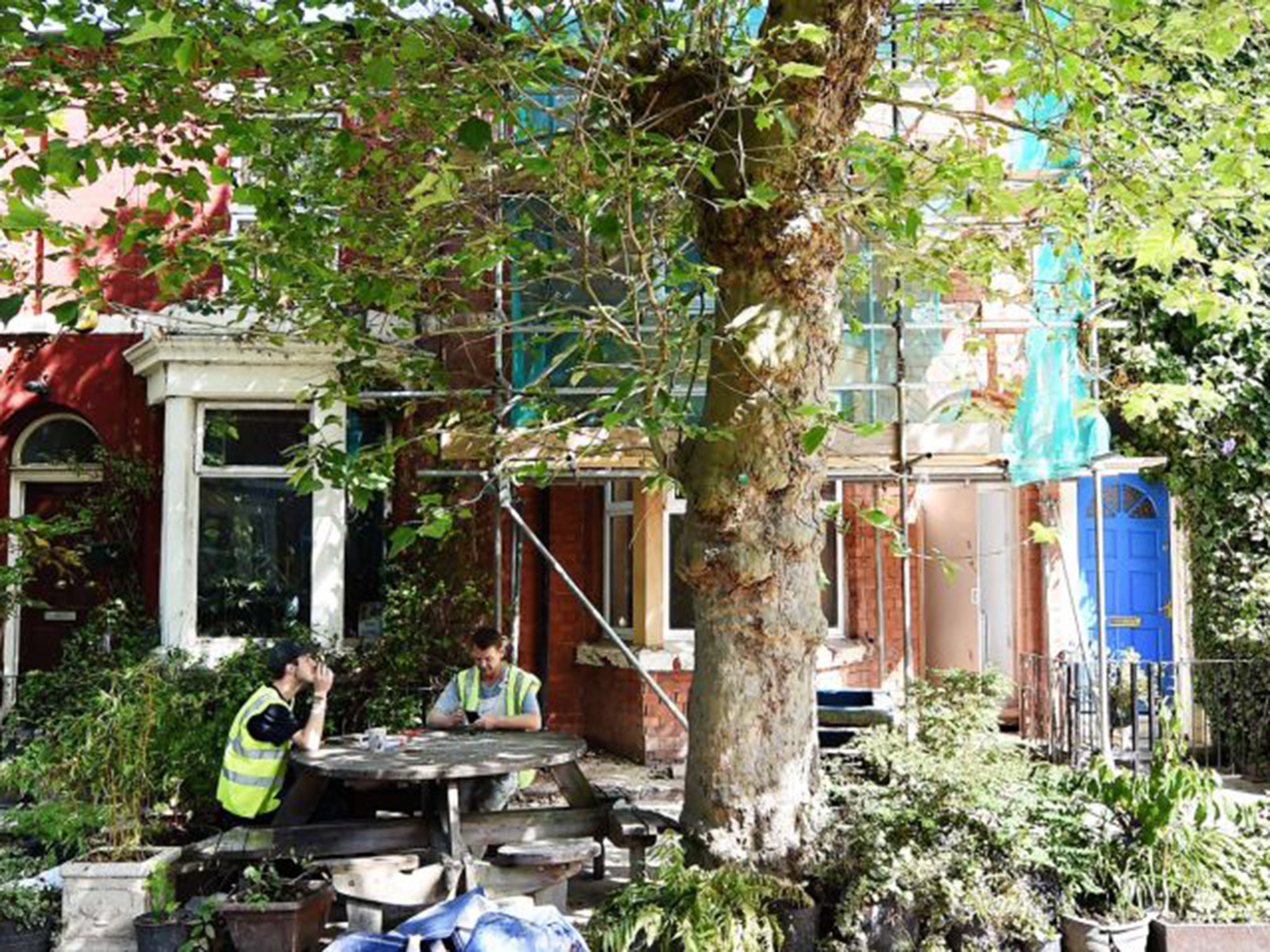 Builders taking a break outside one of the houses designed by the Turner Prize-winning Assemble collective in Cairns Street, part of the Granby Four Streets area in Liverpool