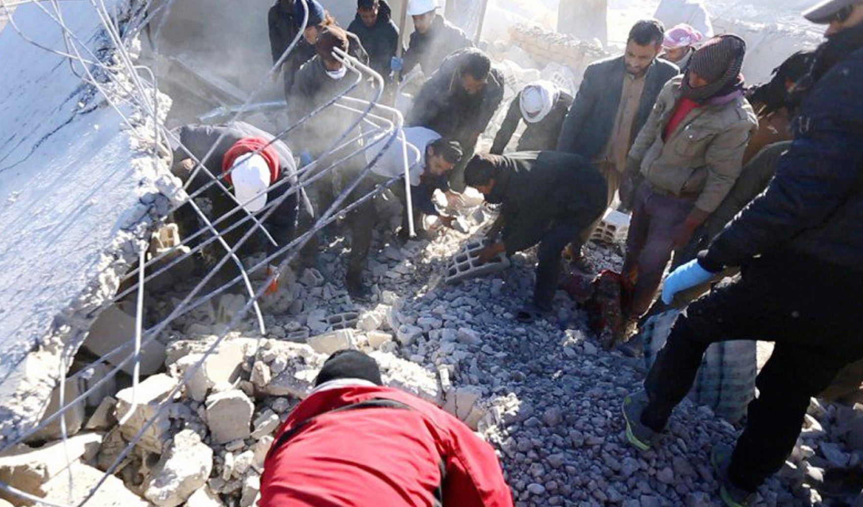 An image posted by Isis supporters shows Syrians inspecting a damaged building in the aftermath of an airstrike on Sunday.