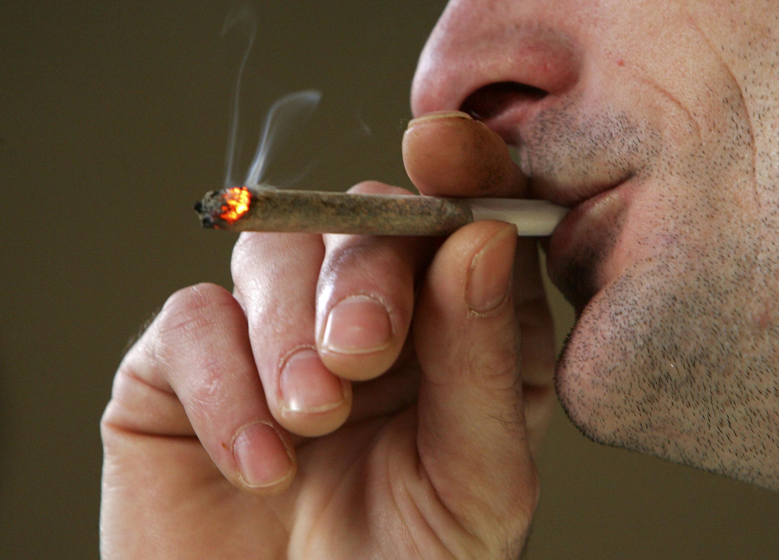 A man smokes a joint in an Amsterdam coffee shop