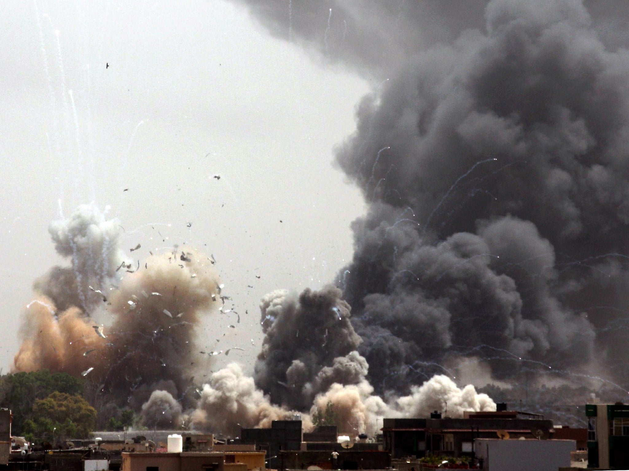 Smoke billows from the site of an explosion near Gaddafi's residence, in Tripoli, following Nato air strikes in 2011 (Getty)