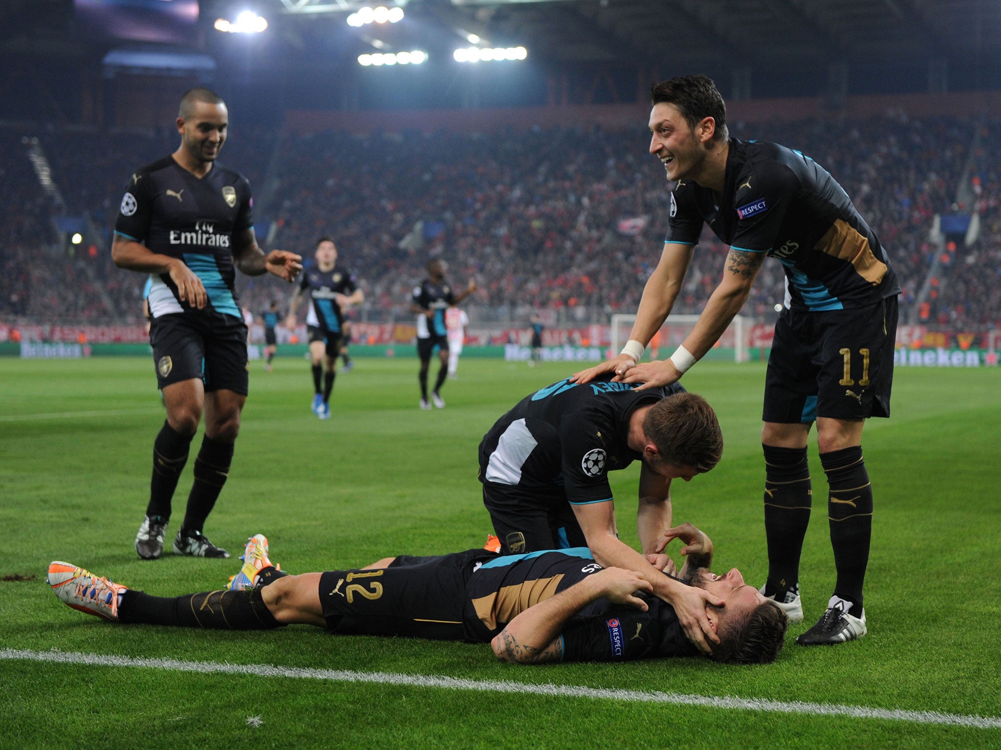 Olivier Giroud is congratulated by his Arsenal team-mates