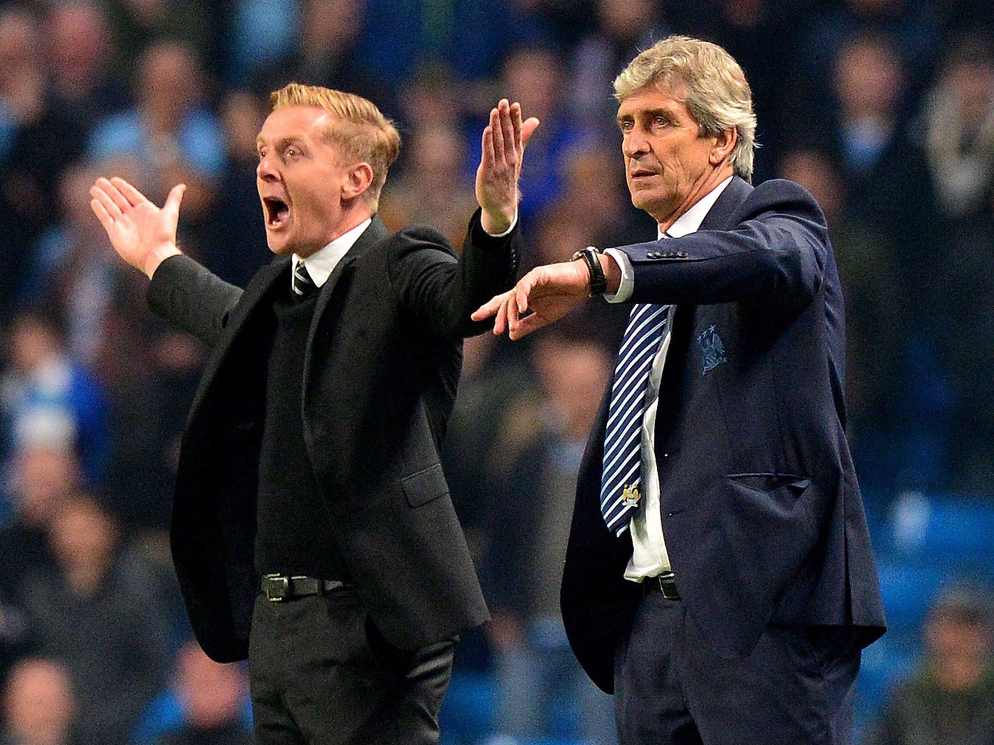 Former Swansea manager Garry Monk alongside Manuel Pellegrini of Manchester City