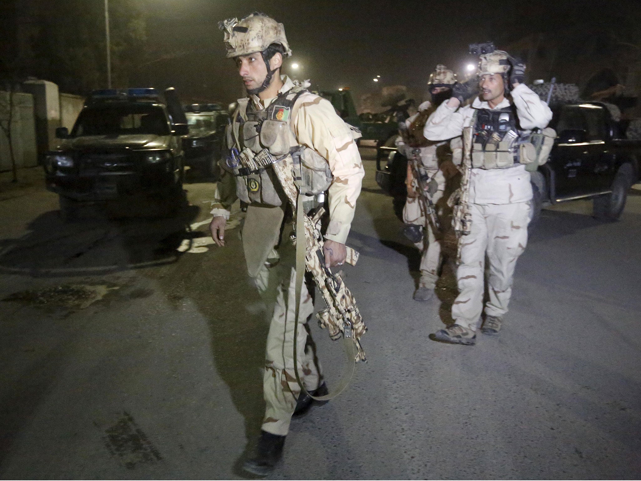 Members of Afghan Crisis Response Unit arrive at the site of a Taliban attack near several foreign embassies and government buildings in the Afghan capital of Kabul, 11 December