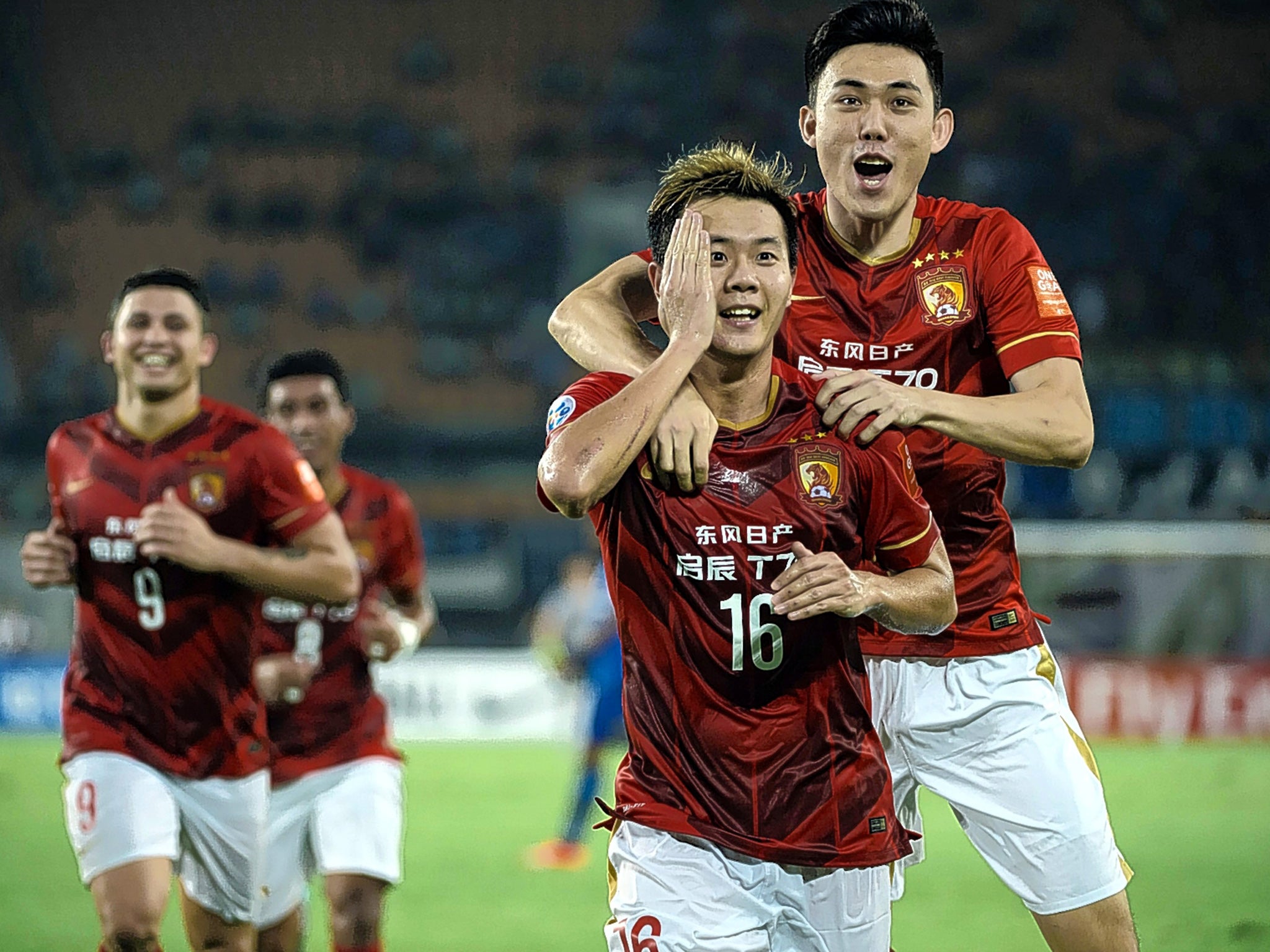 Huang Bowen (second right) celebrates a goal during Guangzhou Evergrande Taobao’s successful Asian Champions League campaign