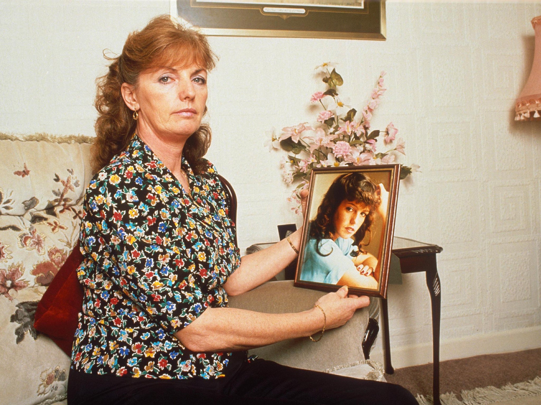 Marie McCourt, pictured, with a photo of her daughter, Helen, who disappeared in 1988 at the age of 22