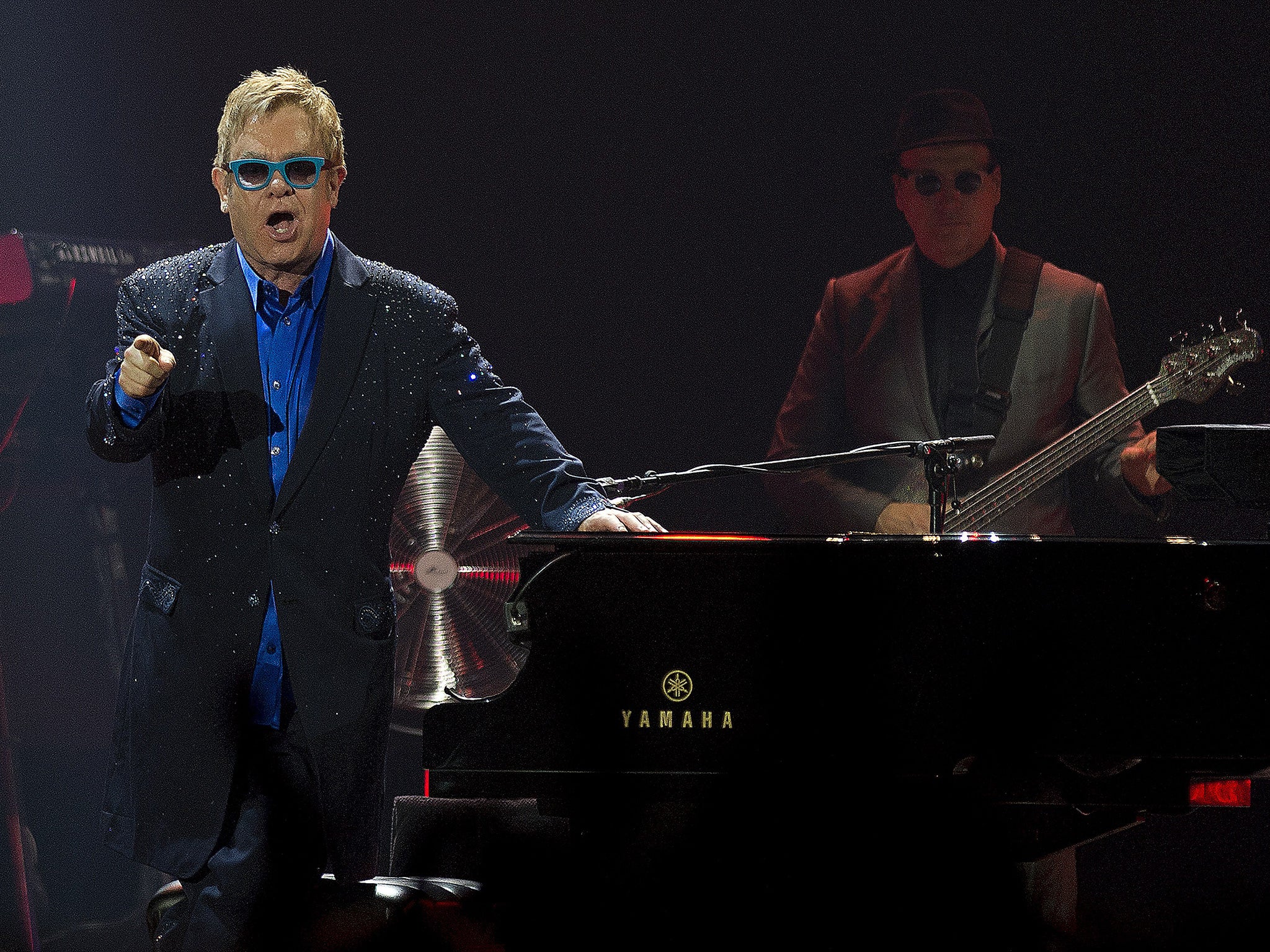 Elton John, pictured here performing in Malaga, played to rain-soaked fans in Exeter on Sunday