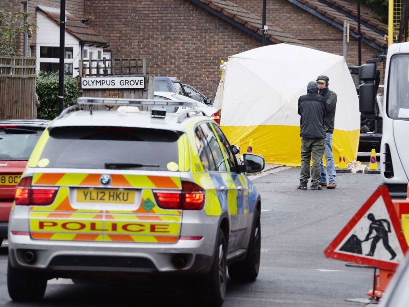 Police officers stand at the scene of the shooting in Wood Green, London