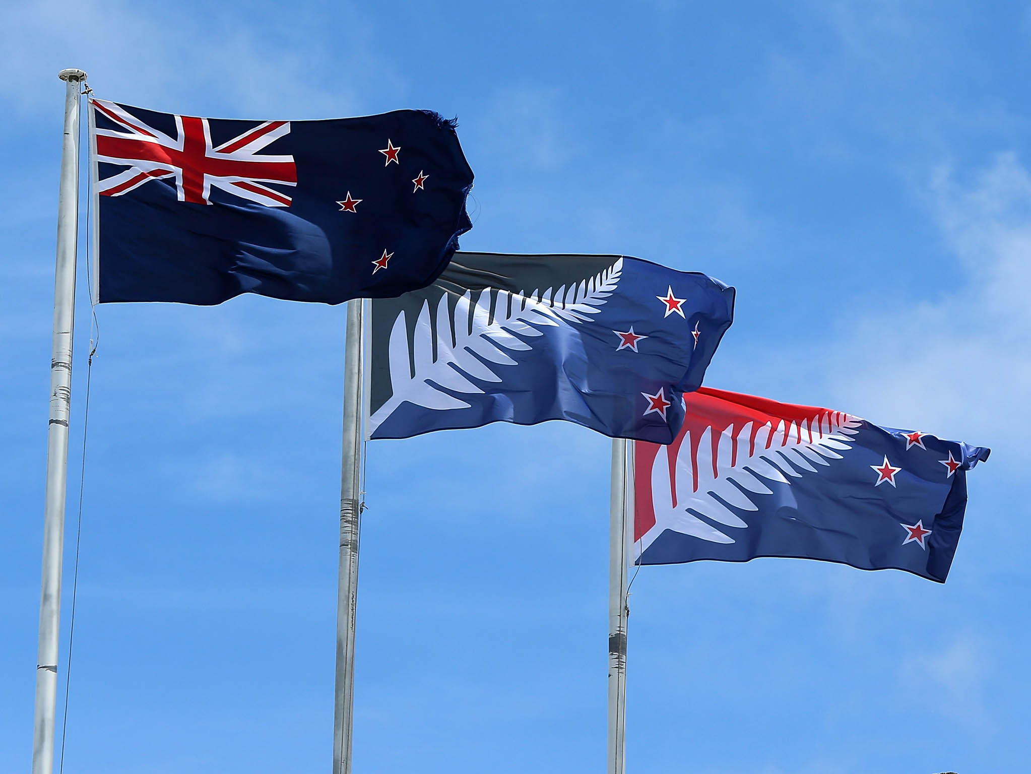 The current New Zealand flag (L) the referendum winning blue and black Kyle Lockwood designed flag (C) and the second placed red and blue flag (R)