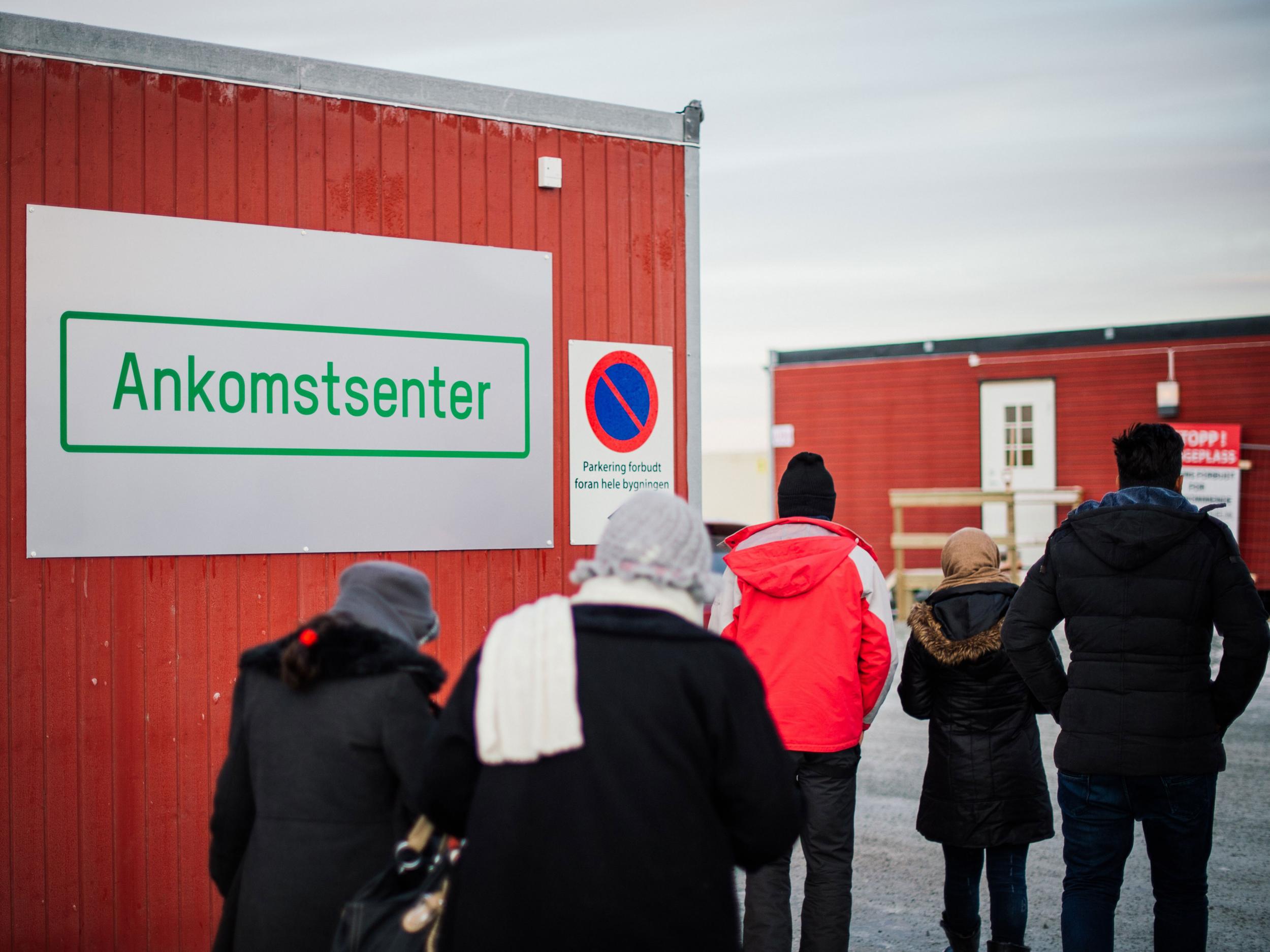 Refugees enter the arrival centre for refugees near the town on Kirkenes, northern Norway, close to the Russian - Norwegian border