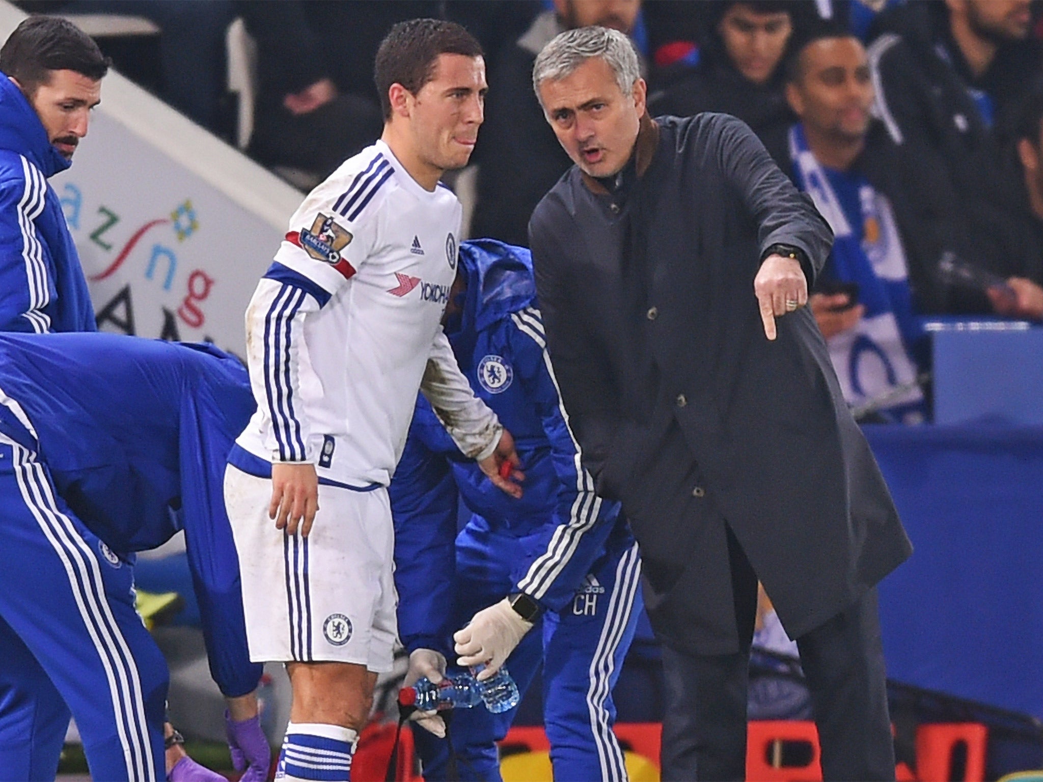 Jose Mourinho talks to Eden Hazard as he receives treatment at Leicester. Hazard soon went off and waved his hand dismissively at his manager