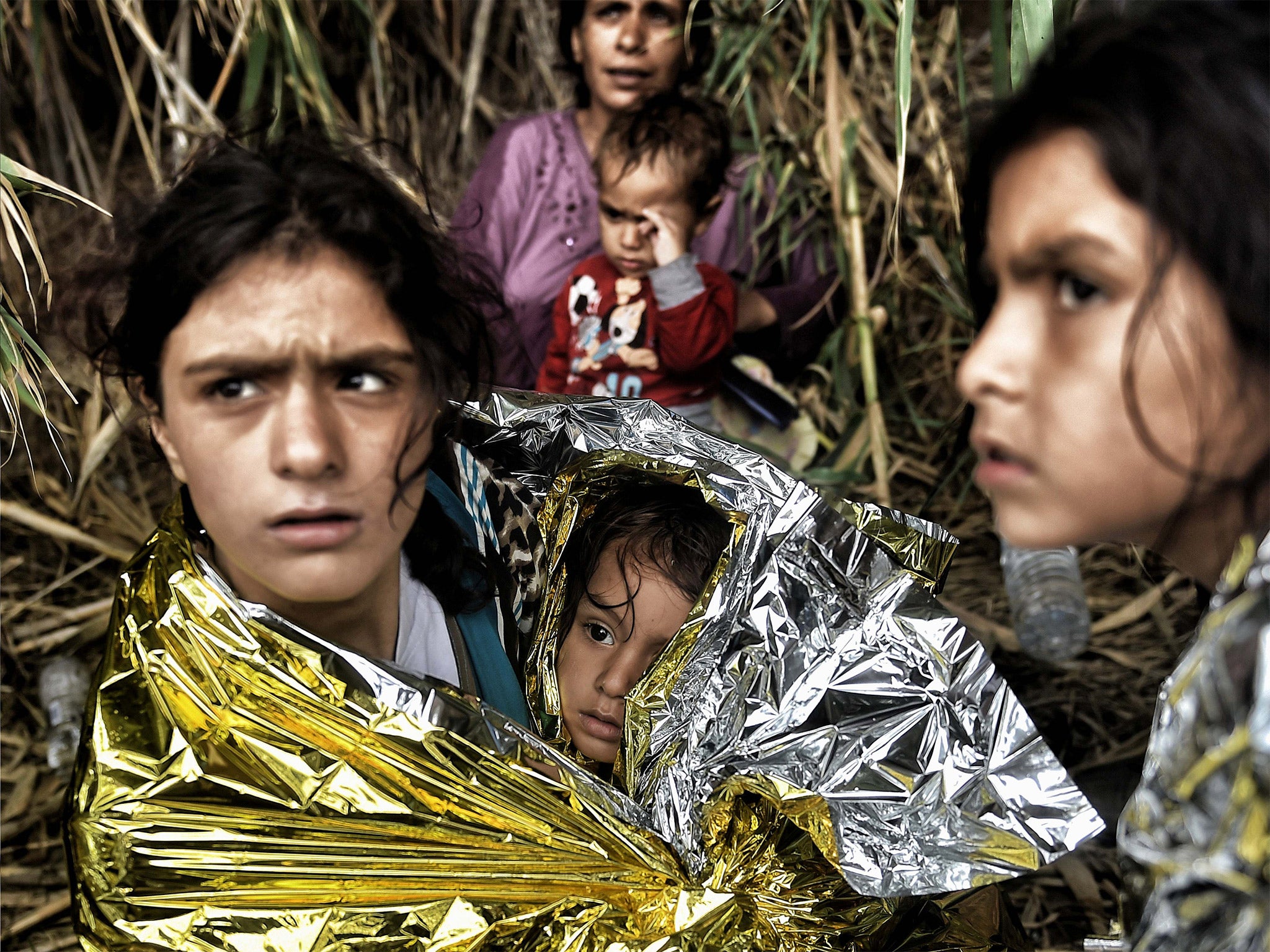 Syrian refugees arrive on the Greek island of Lesbos after crossing the Aegean sea from Turkey