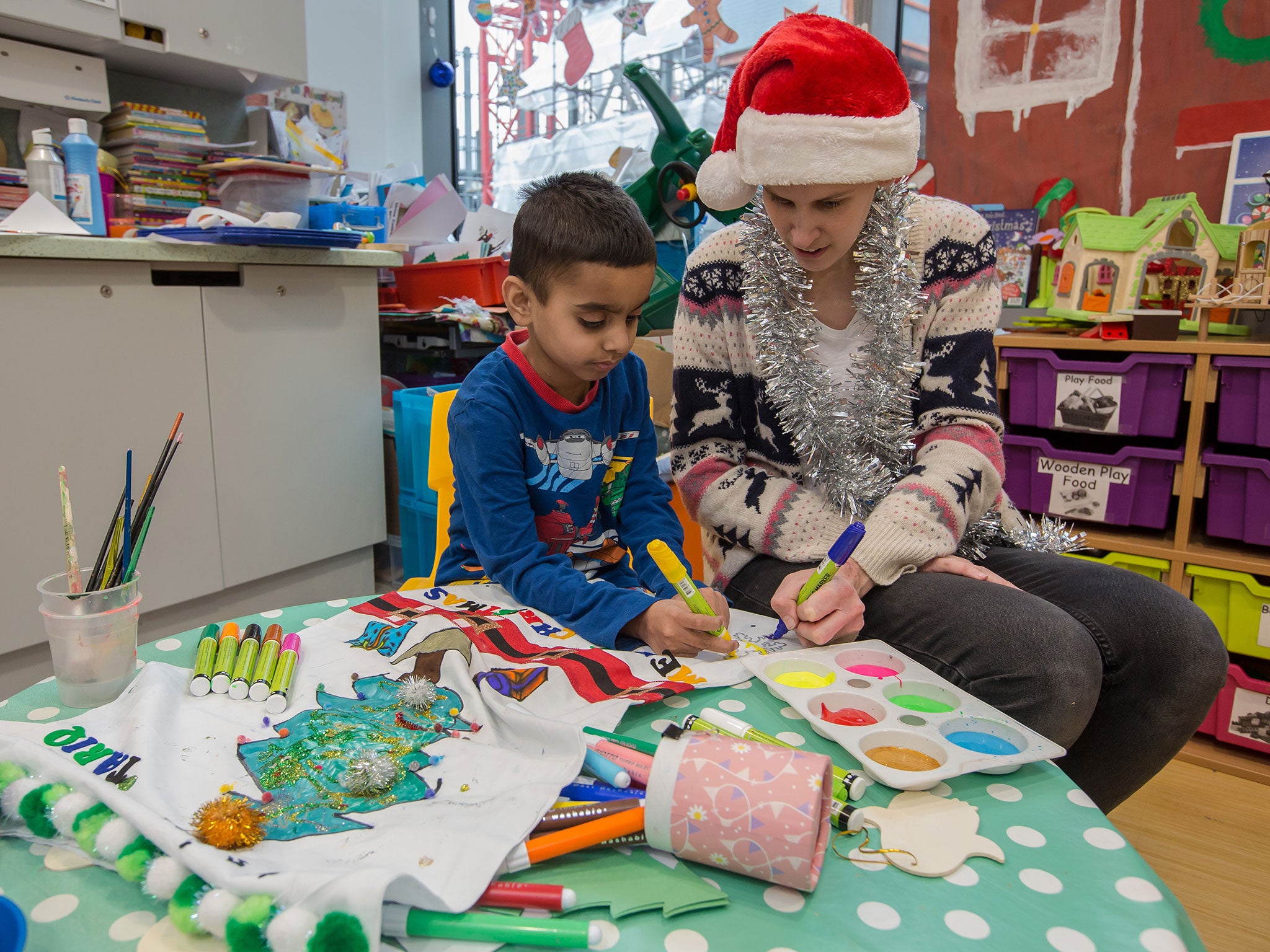 Hashim Tariq with play specialist Lynsey Steele