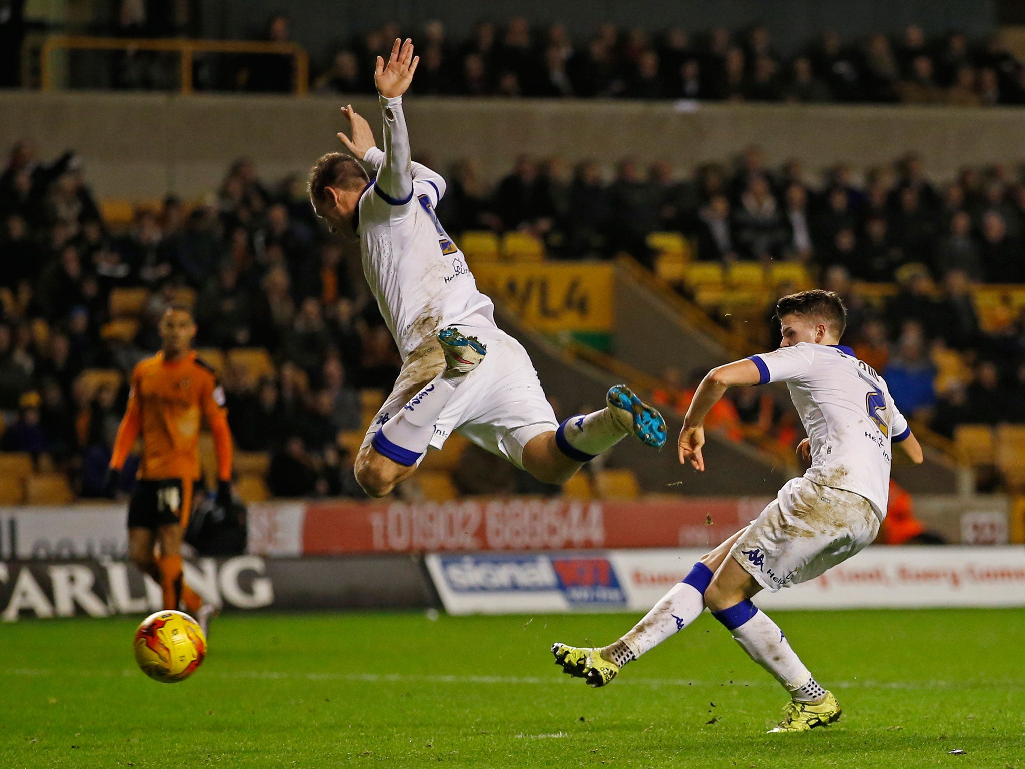 Chris Wood jumps out of the way to allow Sam Byram to score Leeds’ equaliser at Molineux