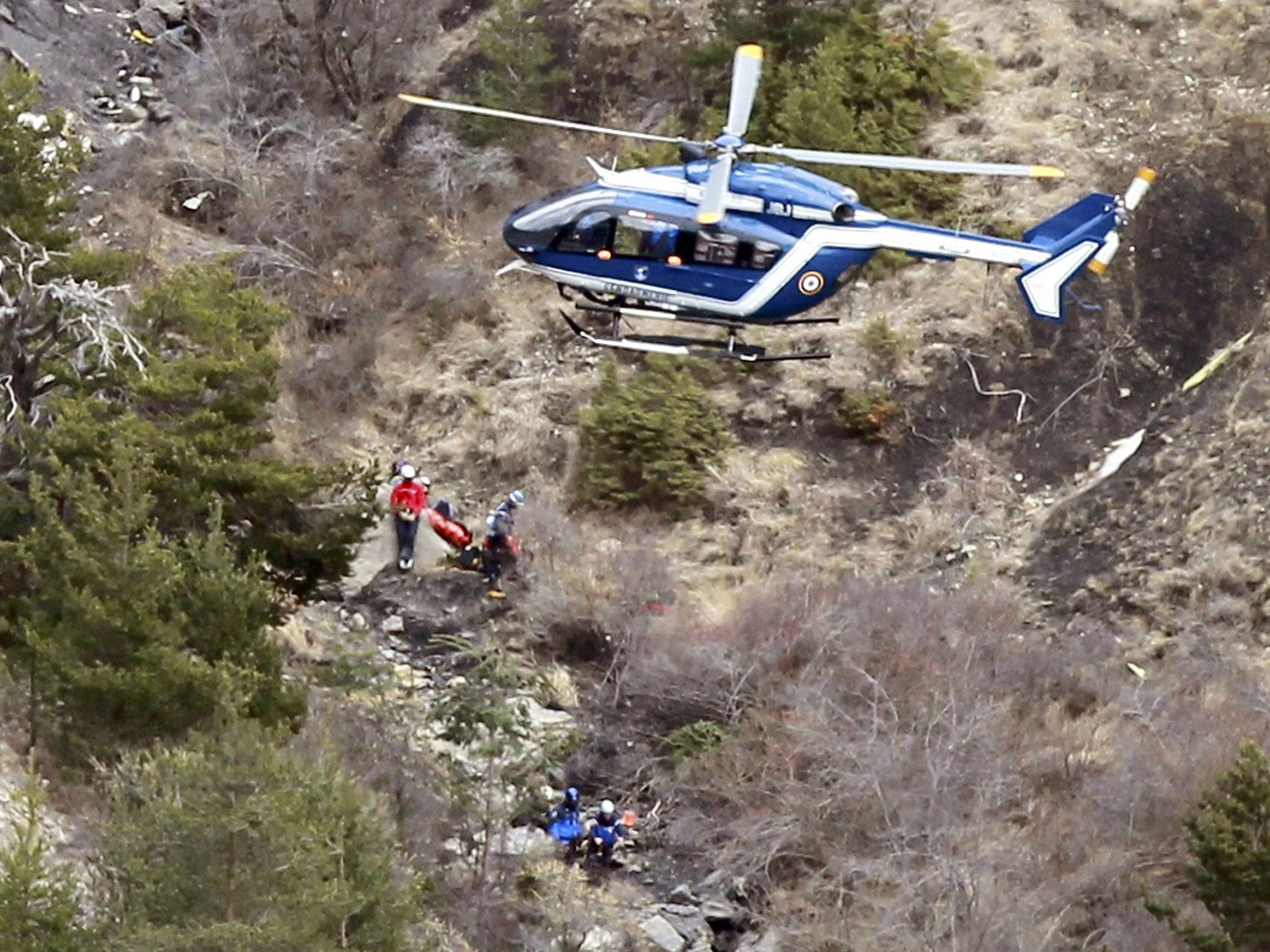 Recovery workers at the site in the French Alps where the plane went down