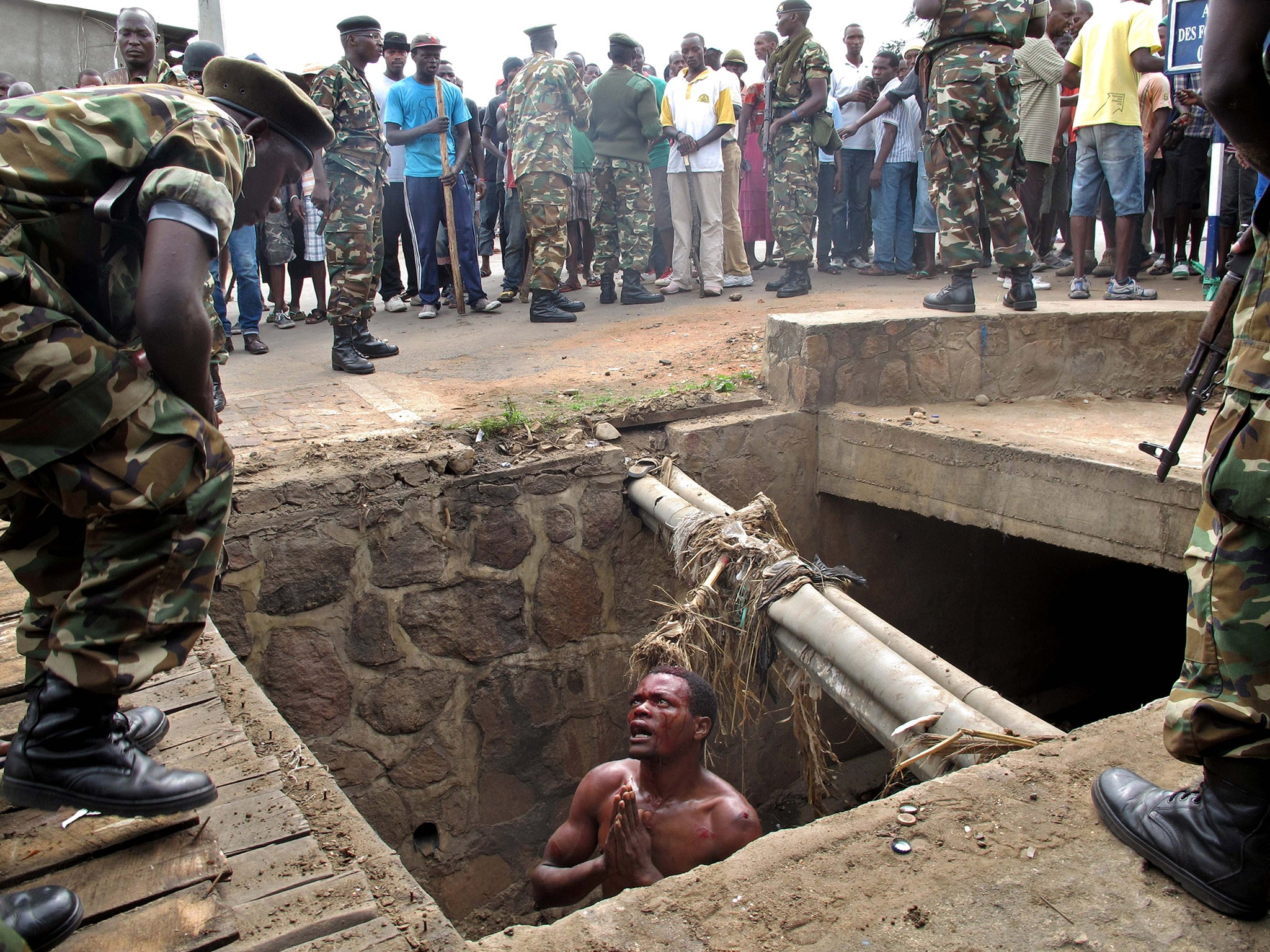 &#13;
A man begs for help from the military after fleeing a political lynch-mob in the Burundi capital&#13;