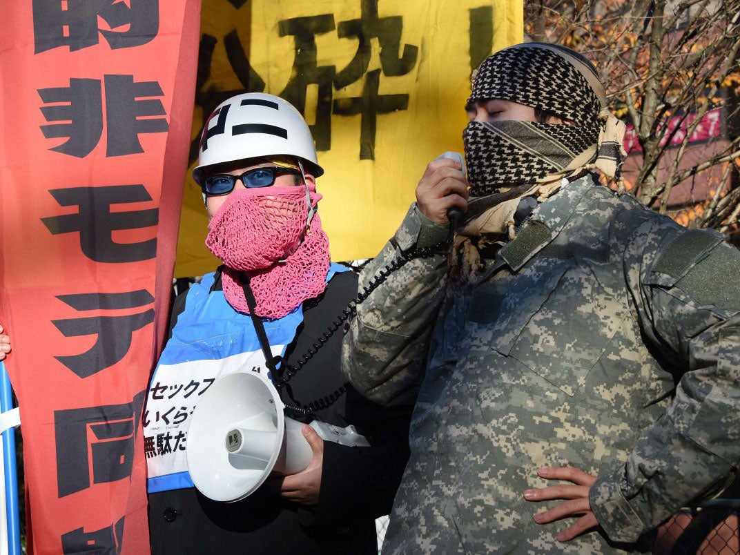 Leaders of a group of men calling themselves "Losers with Women", shout anti-Christmas slogans during a rally