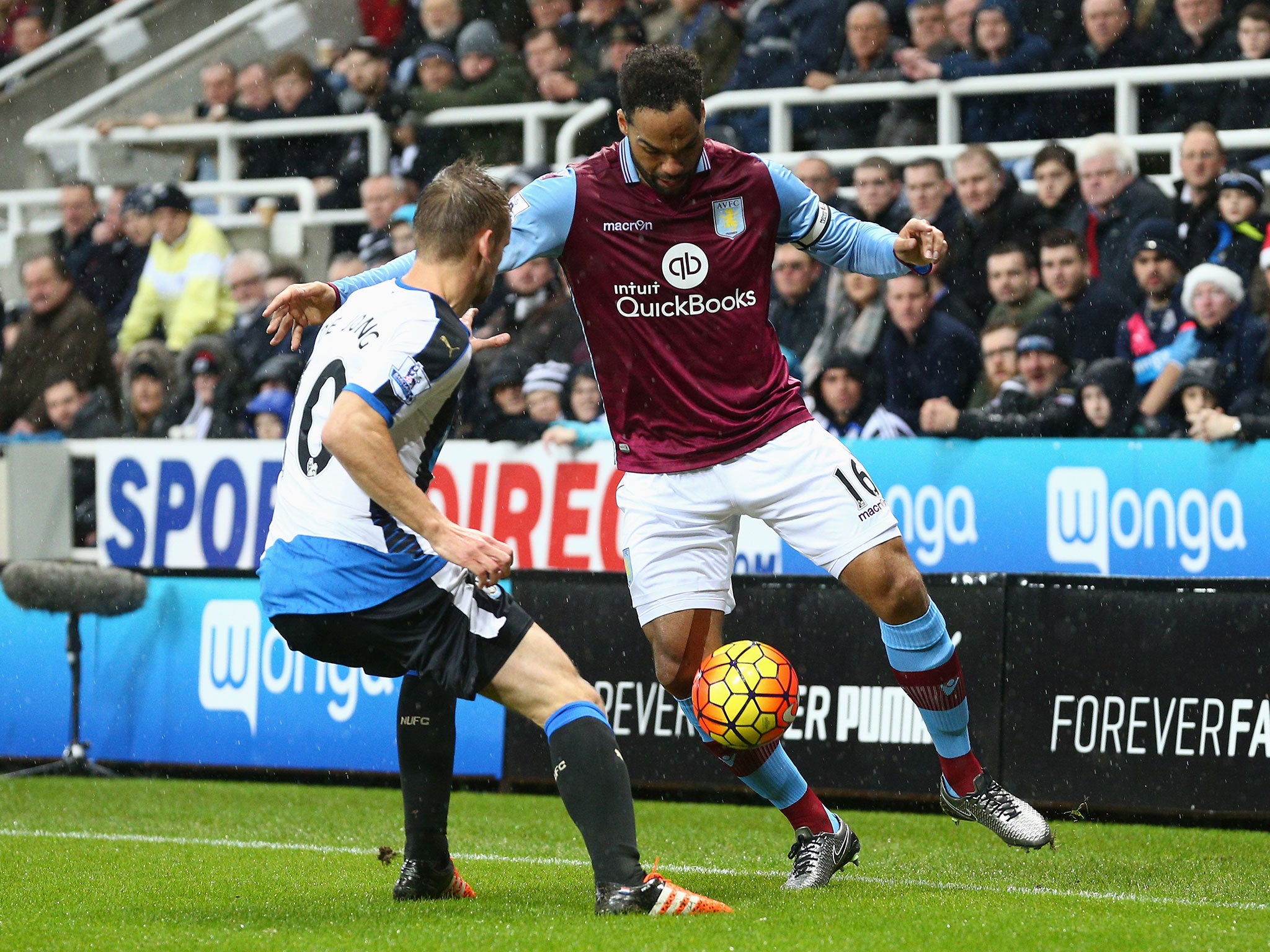 Joleon Lescott jostles with Siem de Jong during Newcastle vs Aston Villa