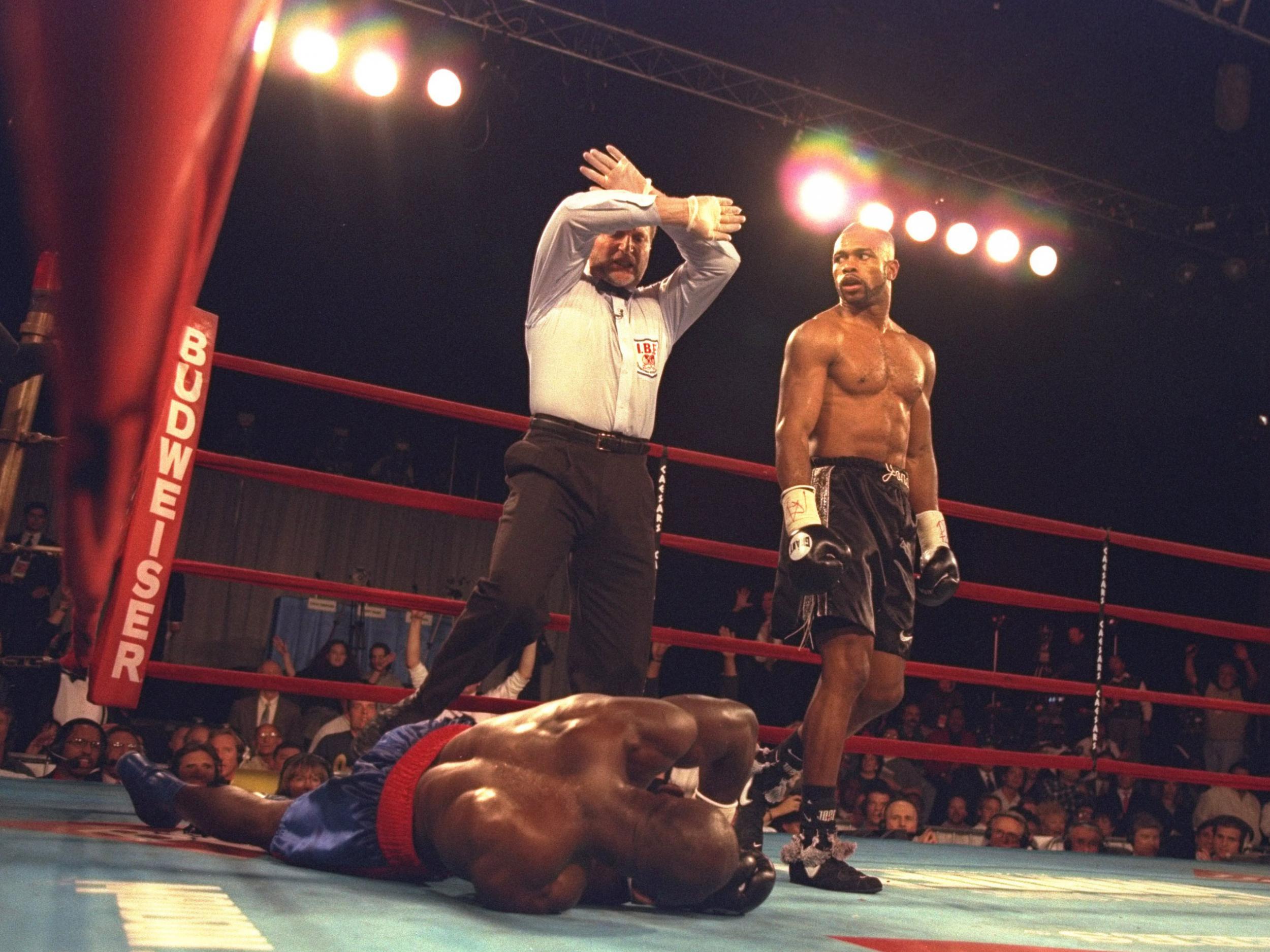 Roy Jones Jr. (right) looks on as the official counts out Bryant Brannon during the second round of a bout at Madison Square Garden in New York City, New York