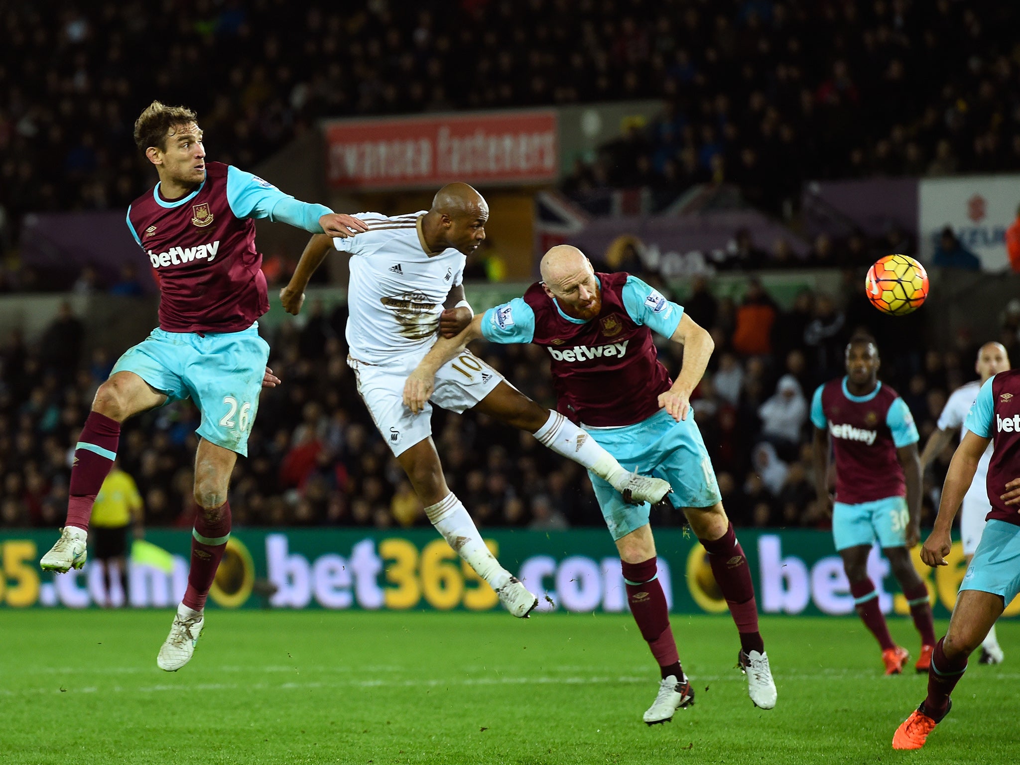 Swansea's Andre Ayew directs a header at goal