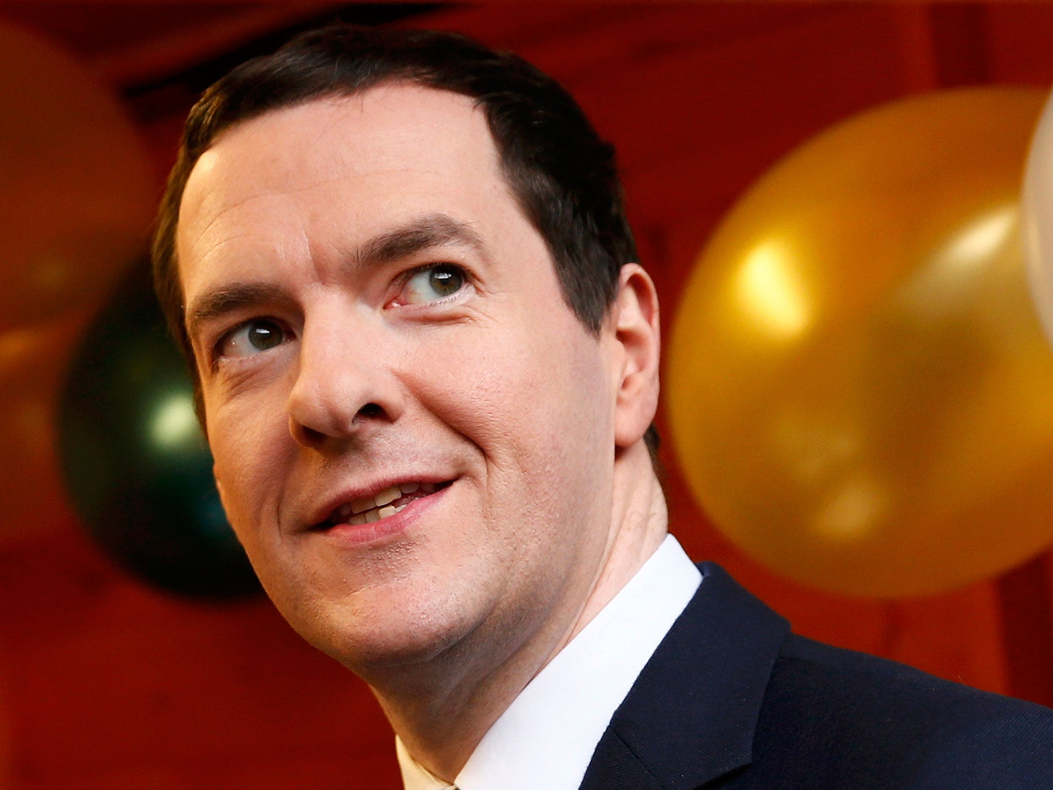 George Osborne samples chocolates during a tour of a Christmas fair at the Treasury on 4 December, 2015