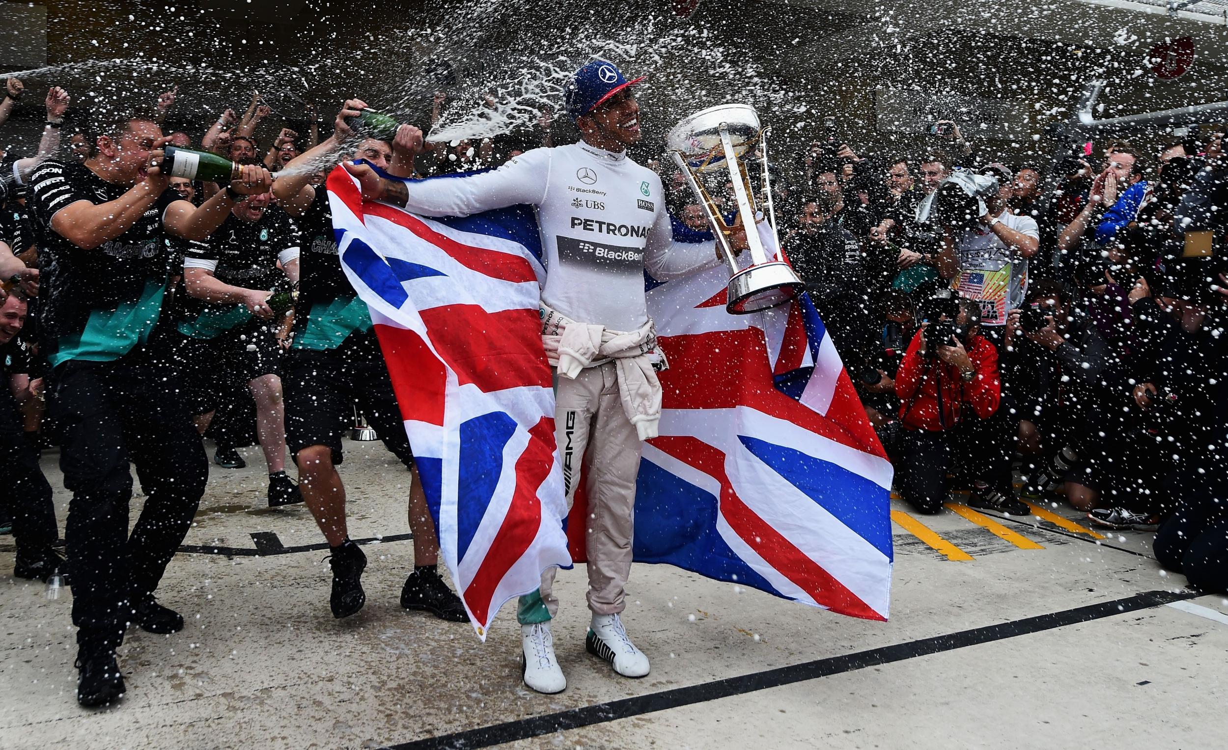 Lewis Hamilton of Great Britain and Mercedes GP celebrates with the team