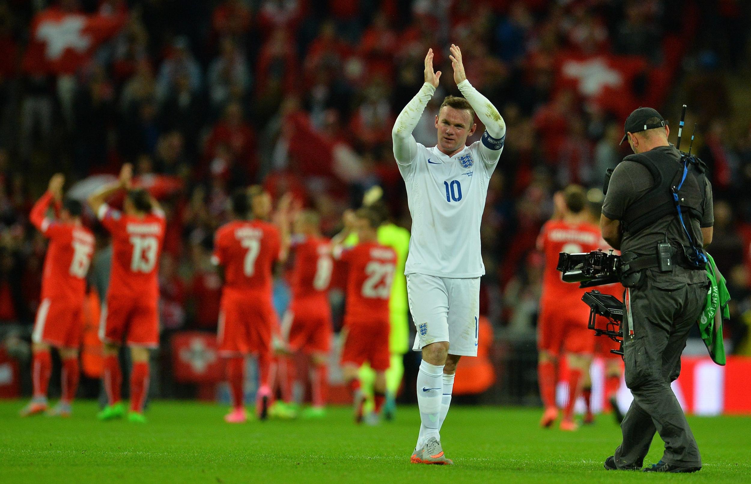 England's striker Wayne Rooney applauds the crowd