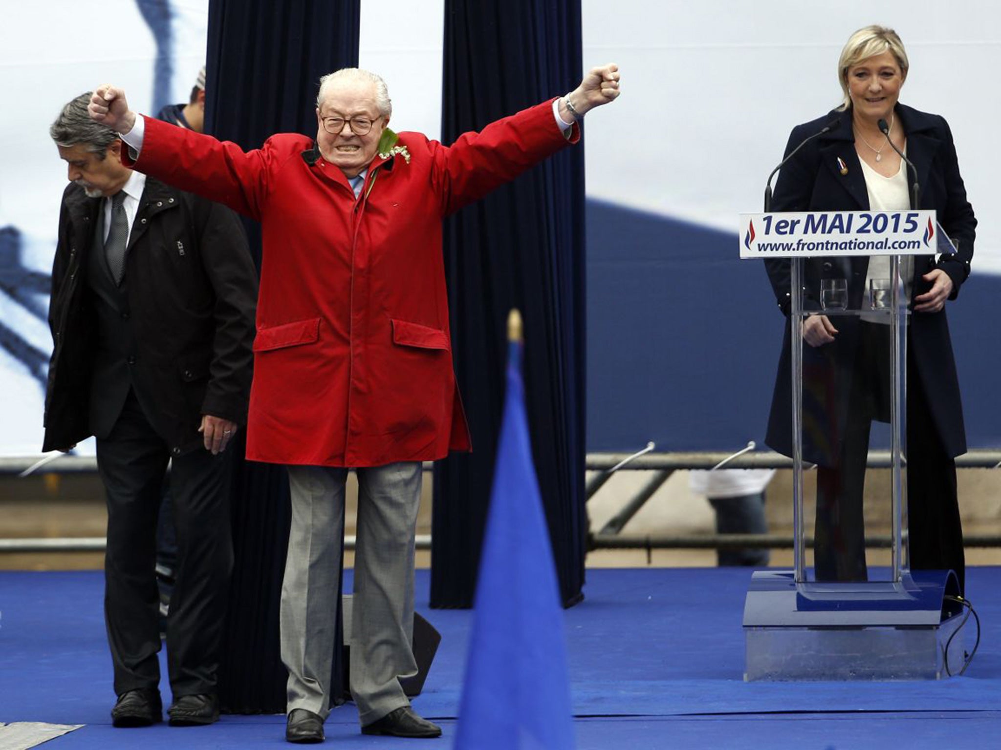 France's far-right political party Front National (FN) founder Jean-Marie Le Pen on stage as Marine Le Pen looks on