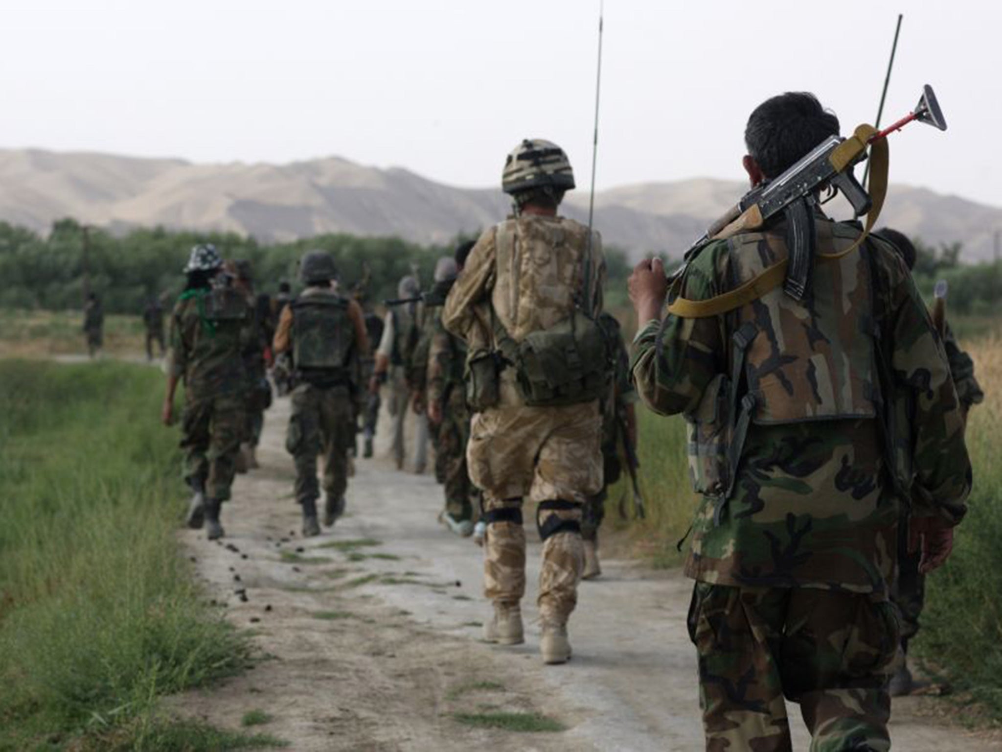 A British Army Officer from the 1st Battalion Welsh Guards patrols with ANA (Afghan National Army) Soldiers in 2007