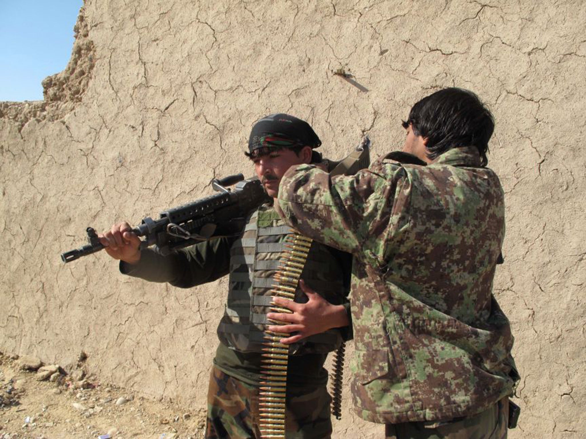 Afghan National Army (ANA) soldiers adjust their equipment in Helmand on December 21, 2015.